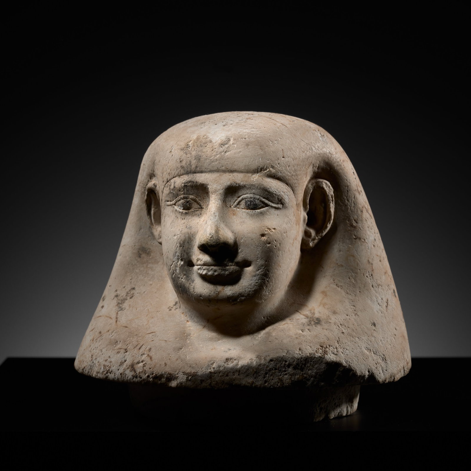 AN EGYPTIAN PAINTED ALABASTER 'IMSETY' CANOPIC JAR HEAD, NEW KINGDOM: AN EGYPTIAN PAINTED ALABASTER 'IMSETY' CANOPIC JAR HEAD, NEW KINGDOM This lot is from a single owner collection and is therefore offered without reserve The Jorgen Ruben Gallery Ledger, entry from 200