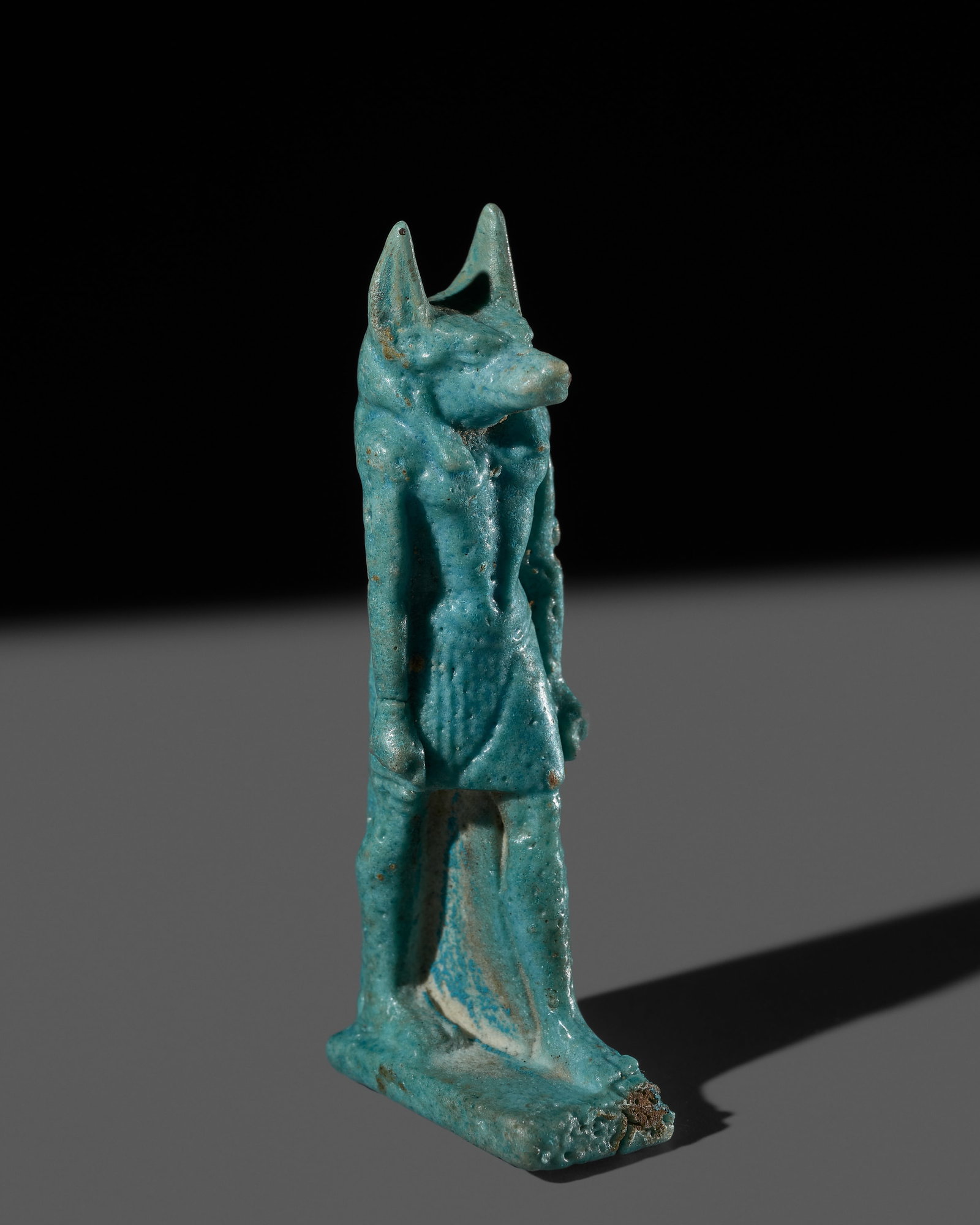 AN EGYPTIAN TURQUOISE FAIENCE 'ANUBIS' AMULET, LATE PERIOD, DYNASTY XXVI: AN EGYPTIAN TURQUOISE FAIENCE 'ANUBIS' AMULET, LATE PERIOD, DYNASTY XXVI This lot is from a single owner collection and is therefore offered without reserve The Jorgen Ruben Gallery Ledger, entry from