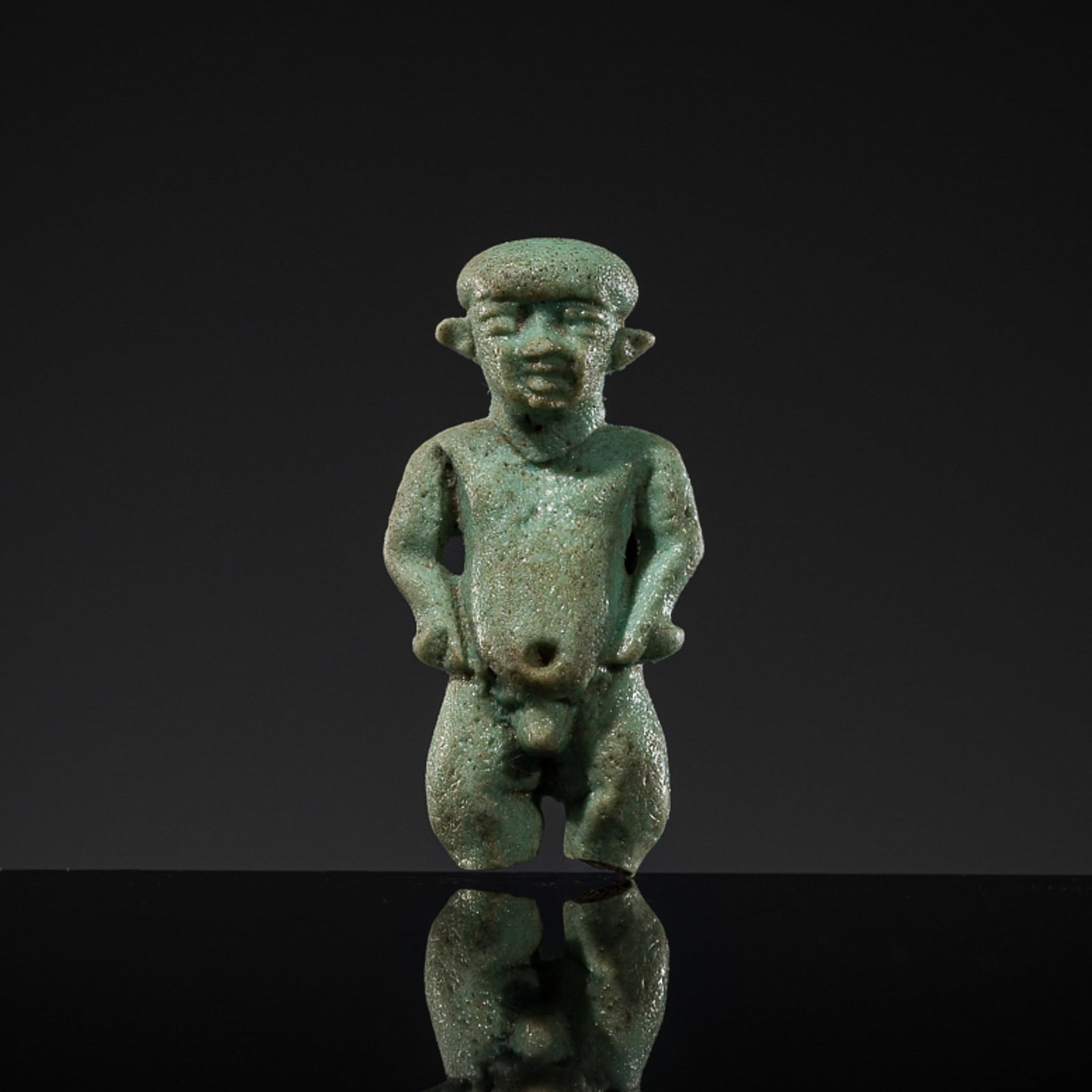AN EGYPTIAN TURQUOISE FAIENCE 'PATAIKOS' AMULET, LATE PERIOD, DYNASTY XXVI: AN EGYPTIAN TURQUOISE FAIENCE 'PATAIKOS' AMULET, LATE PERIOD, DYNASTY XXVI This lot is from a single owner collection and is therefore offered without reserve Egypt, 664-525 BC. Boldly rendered as a n