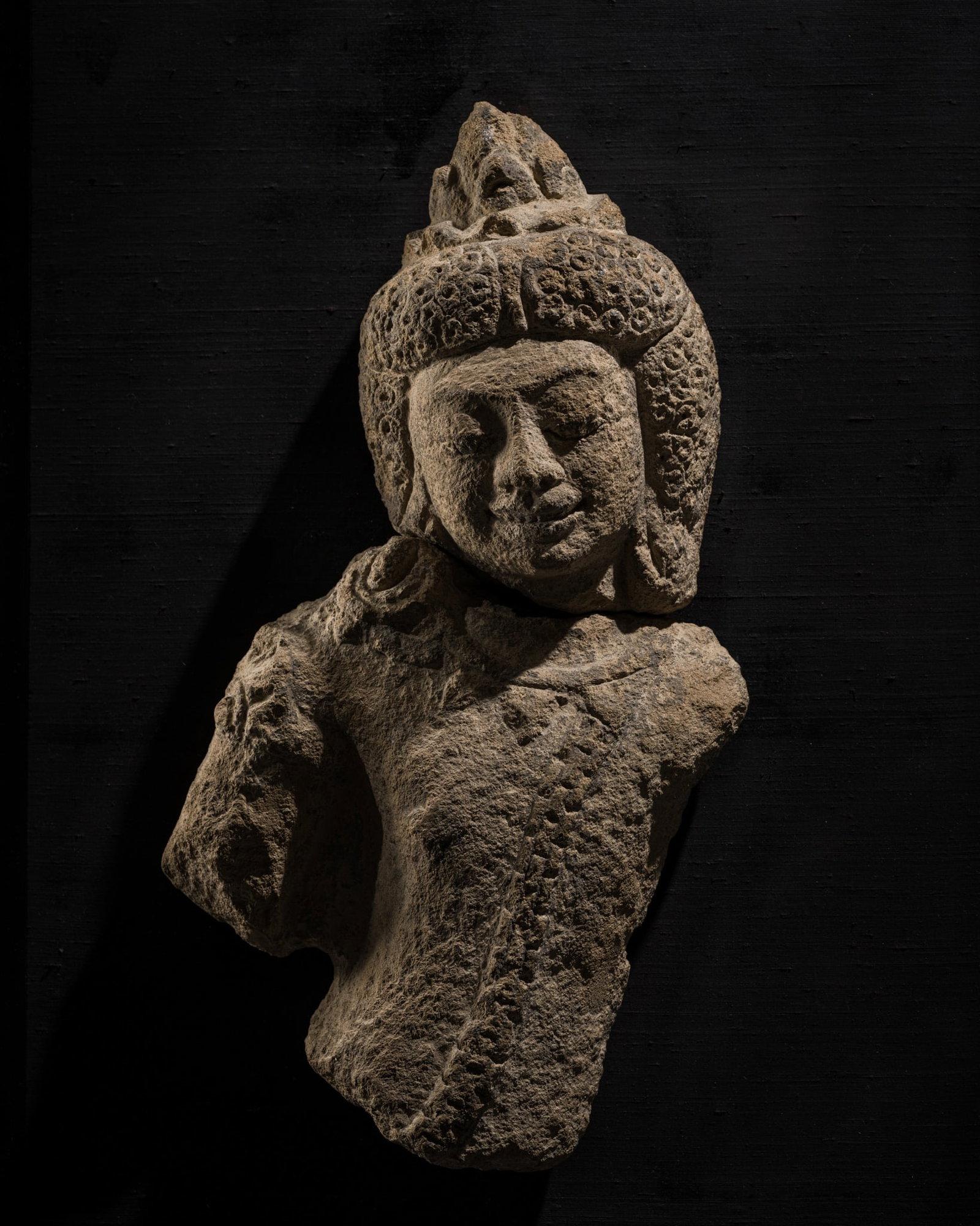 A RARE STONE FIGURE OF A MALE DEITY, MON DVARAVATI PERIOD, 8TH-9TH CENTURY: A RARE STONE FIGURE OF A MALE DEITY, MON DVARAVATI PERIOD, 8TH-9TH CENTURY This lot is from a single owner collection and is therefore offered without reserve Thailand. Finely modeled, the chest adorn