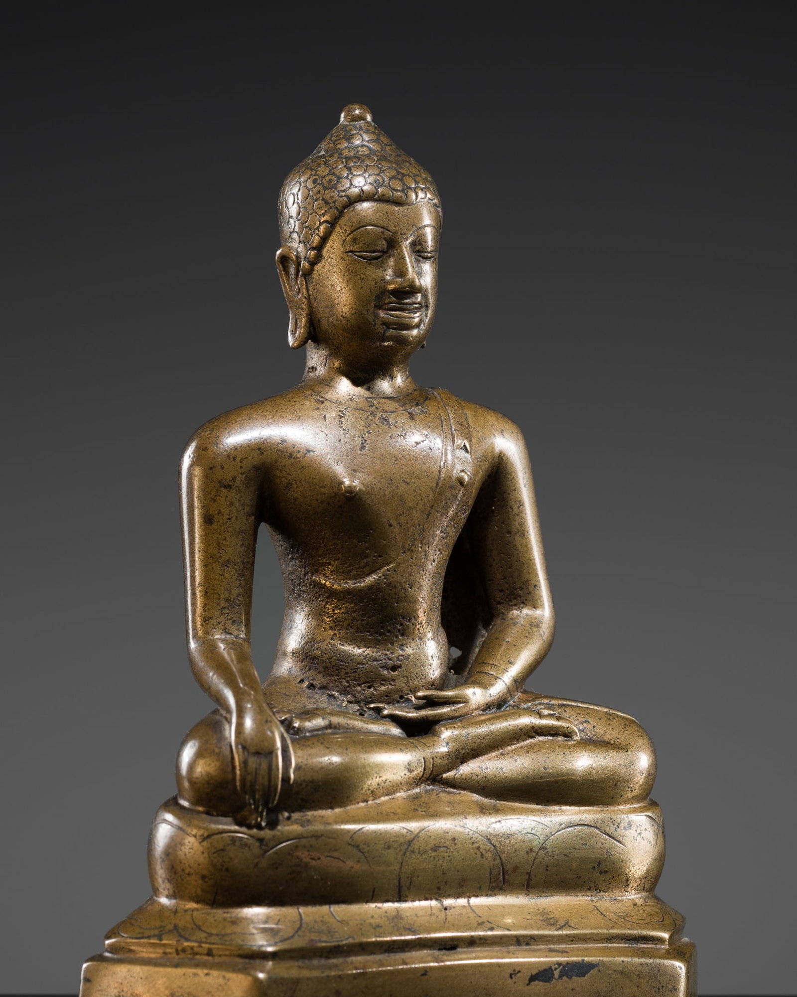 A RARE BRONZE FIGURE OF BUDDHA SHAKYAMUNI, LAN NA KINGDOM, 14TH CENTURY: A RARE BRONZE FIGURE OF BUDDHA SHAKYAMUNI, LAN NA KINGDOM, 14TH CENTURY This lot is from a single owner collection and is therefore offered without reserve Northern Thailand. Finely cast, the Buddha i