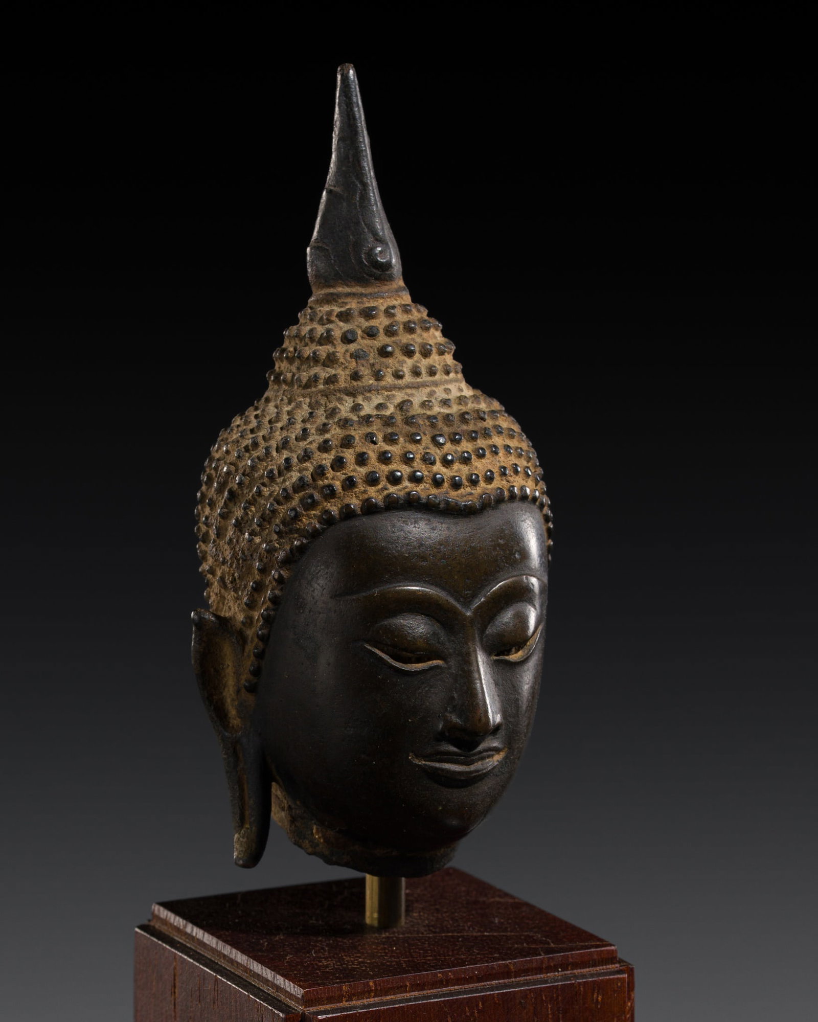 A BRONZE HEAD OF BUDDHA SHAKYAMUNI, AYUTTHAYA KINGDOM, 15TH CENTURY: A BRONZE HEAD OF BUDDHA SHAKYAMUNI, AYUTTHAYA KINGDOM, 15TH CENTURY This lot is from a single owner collection and is therefore offered without reserve Thailand. Finely cast, the sensitively crafted f