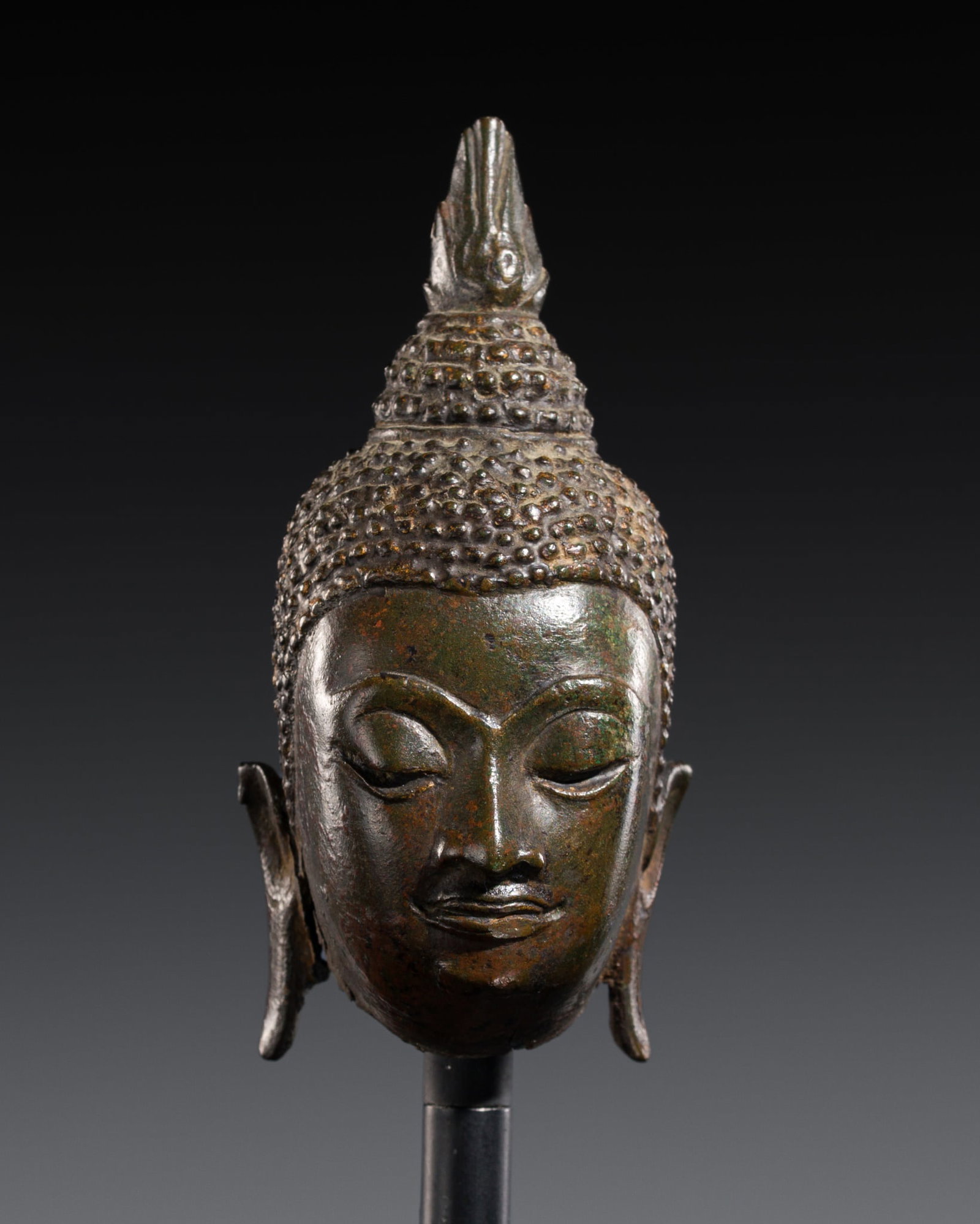 A SMALL BRONZE HEAD OF BUDDHA SHAKYAMUNI, AYUTTHAYA KINGDOM: A SMALL BRONZE HEAD OF BUDDHA SHAKYAMUNI, AYUTTHAYA KINGDOM This lot is from a single owner collection and is therefore offered without reserve Thailand, 15th-16th century. Finely cast, the sensitivel