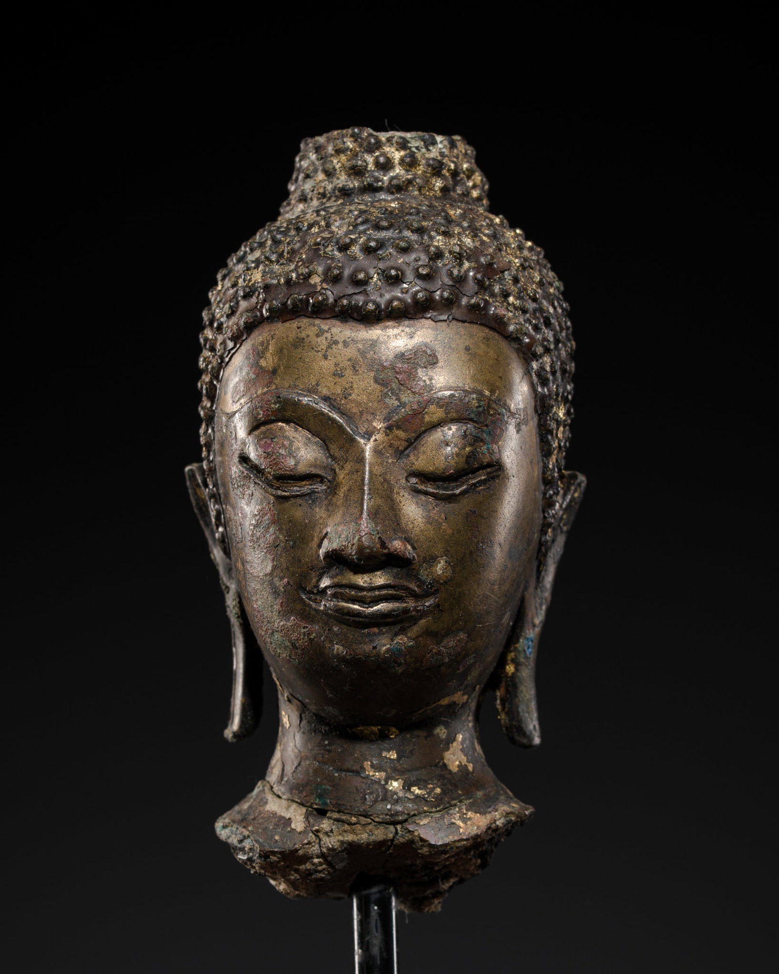 A SMALL GILT BRONZE HEAD OF BUDDHA SHAKYAMUNI, AYUTTHAYA KINGDOM, 15TH-16TH CENTURY: A SMALL GILT BRONZE HEAD OF BUDDHA SHAKYAMUNI, AYUTTHAYA KINGDOM, 15TH-16TH CENTURY This lot is from a single owner collection and is therefore offered without reserve The Jorgen Ruben Gallery Ledger,