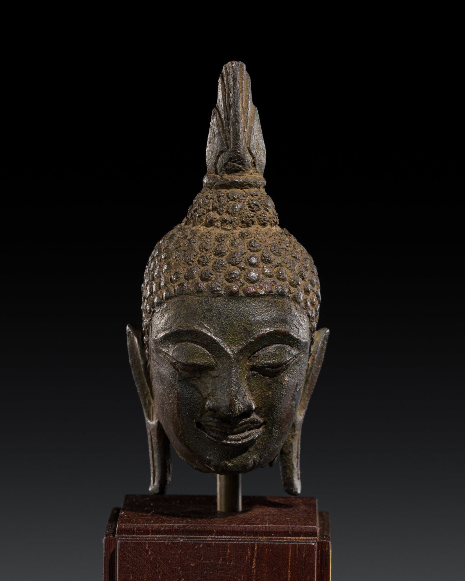 A SMALL BRONZE HEAD OF BUDDHA SHAKYAMUNI, AYUTTHAYA KINGDOM, 16TH CENTURY: A SMALL BRONZE HEAD OF BUDDHA SHAKYAMUNI, AYUTTHAYA KINGDOM, 16TH CENTURY This lot is from a single owner collection and is therefore offered without reserve Thailand. Skillfully cast, the face serene