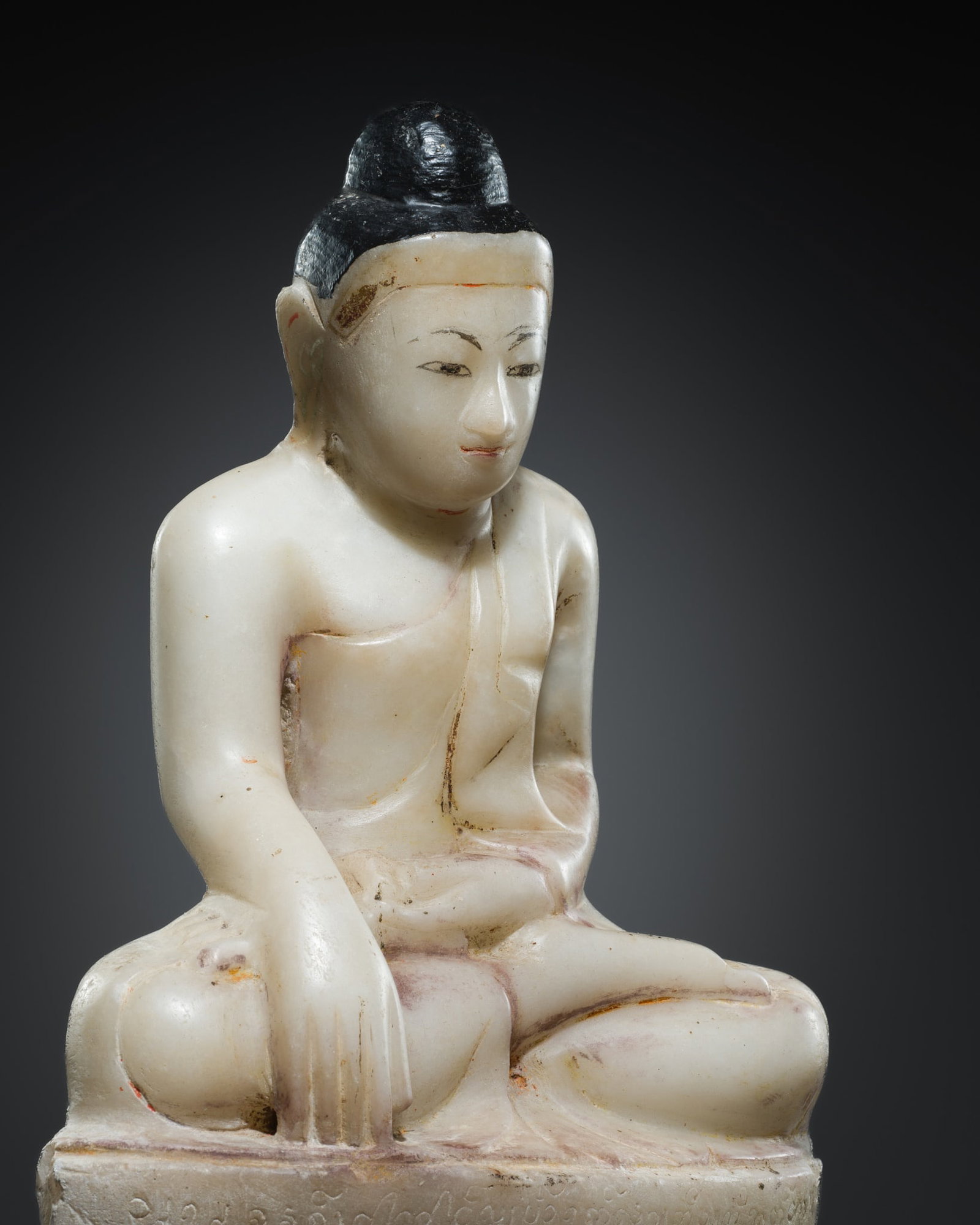 AN INSCRIBED ALABASTER FIGURE OF BUDDHA, MANDALAY, 18TH-19TH CENTURY: AN INSCRIBED ALABASTER FIGURE OF BUDDHA, MANDALAY, 18TH-19TH CENTURY This lot is from a single owner collection and is therefore offered without reserve Burma. Finely carved, the Buddha is seated in d