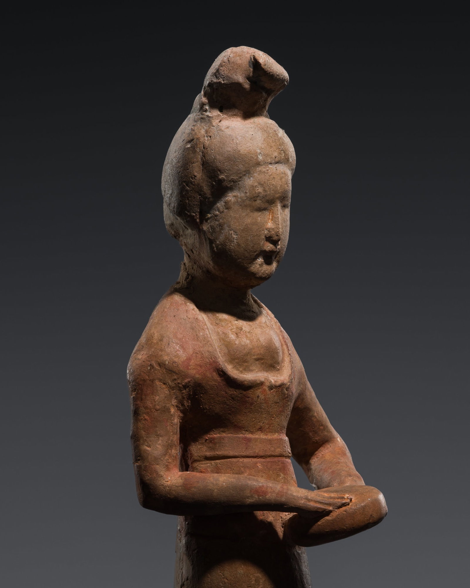 A PAINTED POTTERY FIGURE OF A FEMALE DRUMMER, TANG DYNASTY: A PAINTED POTTERY FIGURE OF A FEMALE DRUMMER, TANG DYNASTY This lot is from a single owner collection and is therefore offered without reserve Exhibited: Exhibition of Chinese Art, City Art Gallery, M