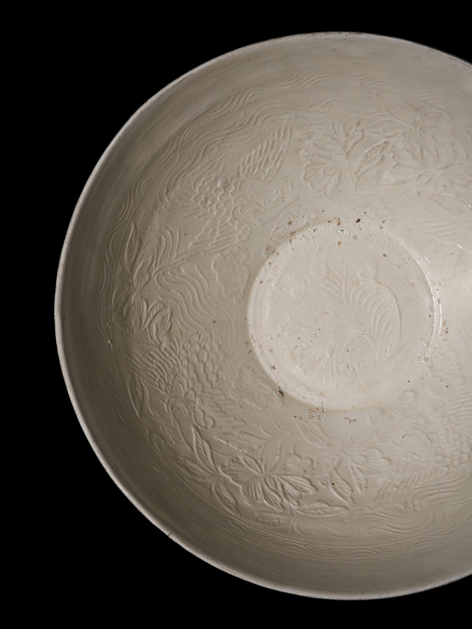 A FINE MOLDED DING-TYPE 'PHOENIX' BOWL, NORTHERN SONG DYNASTY: A FINE MOLDED DING-TYPE 'PHOENIX' BOWL, NORTHERN SONG DYNASTY This lot is from a single owner collection and is therefore offered without reserve China, 960-1127. Delicately potted with rounded sides 
