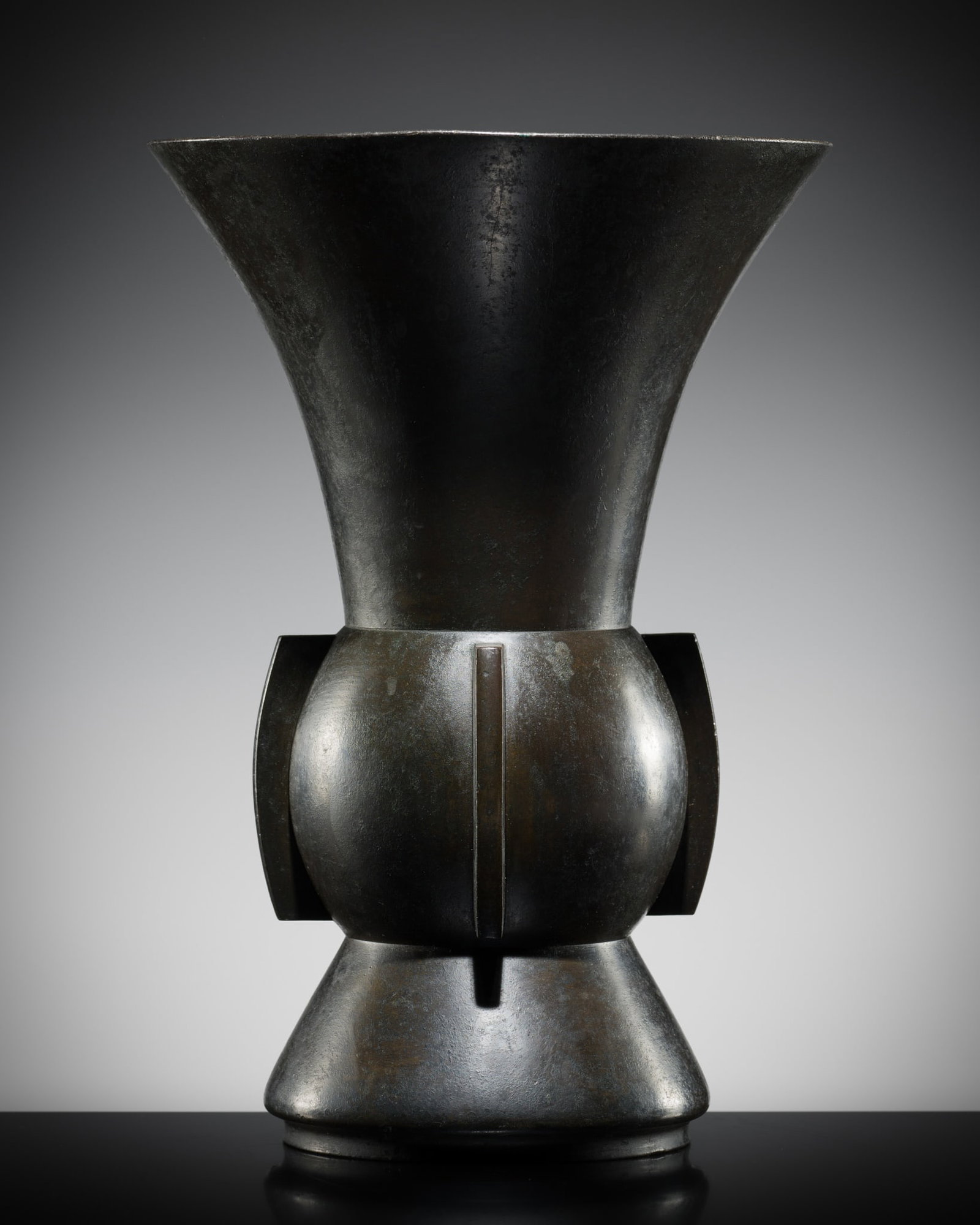A BRONZE VASE, ZUN, YUAN-MING DYNASTY: A BRONZE VASE, ZUN, YUAN-MING DYNASTY This lot is from a single owner collection and is therefore offered without reserve China, 1279-1644. Heavily cast, the globular body supported on a tall spreadin