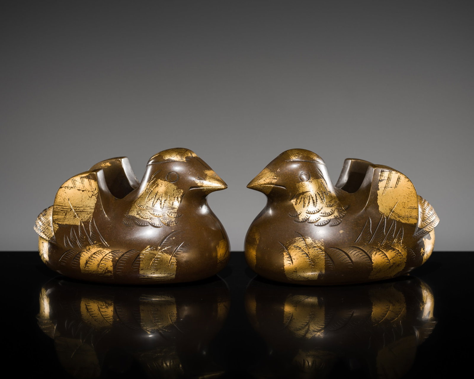 A PAIR OF PARCEL-GILT BRONZE 'MANDARIN DUCK' BYOBU UKE (SCREEN HOLDERS), MEIJI PERIOD: A PAIR OF PARCEL-GILT BRONZE 'MANDARIN DUCK' BYOBU UKE (SCREEN HOLDERS), MEIJI PERIOD This lot is from a single owner collection and is therefore offered without reserve Japan, 1868-1912. Each heavily