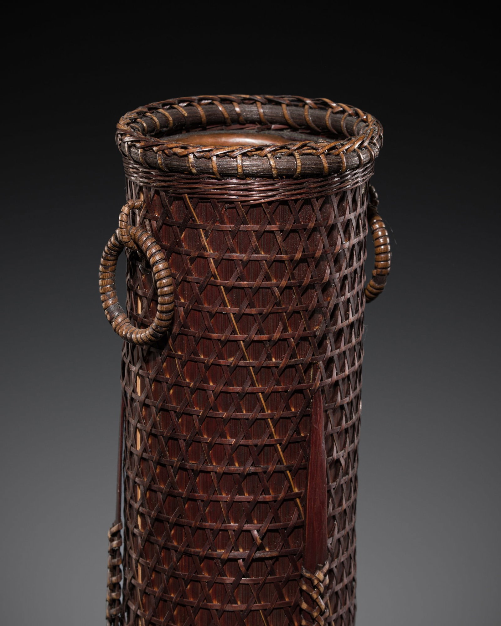 A FINE WOVEN RATTAN AND BAMBOO HANAKAGO, MEIJI PERIOD: A FINE WOVEN RATTAN AND BAMBOO HANAKAGO, MEIJI PERIOD This lot is from a single owner collection and is therefore offered without reserve Japan, 1868-1912. Of tubular form, the inner walls carved from