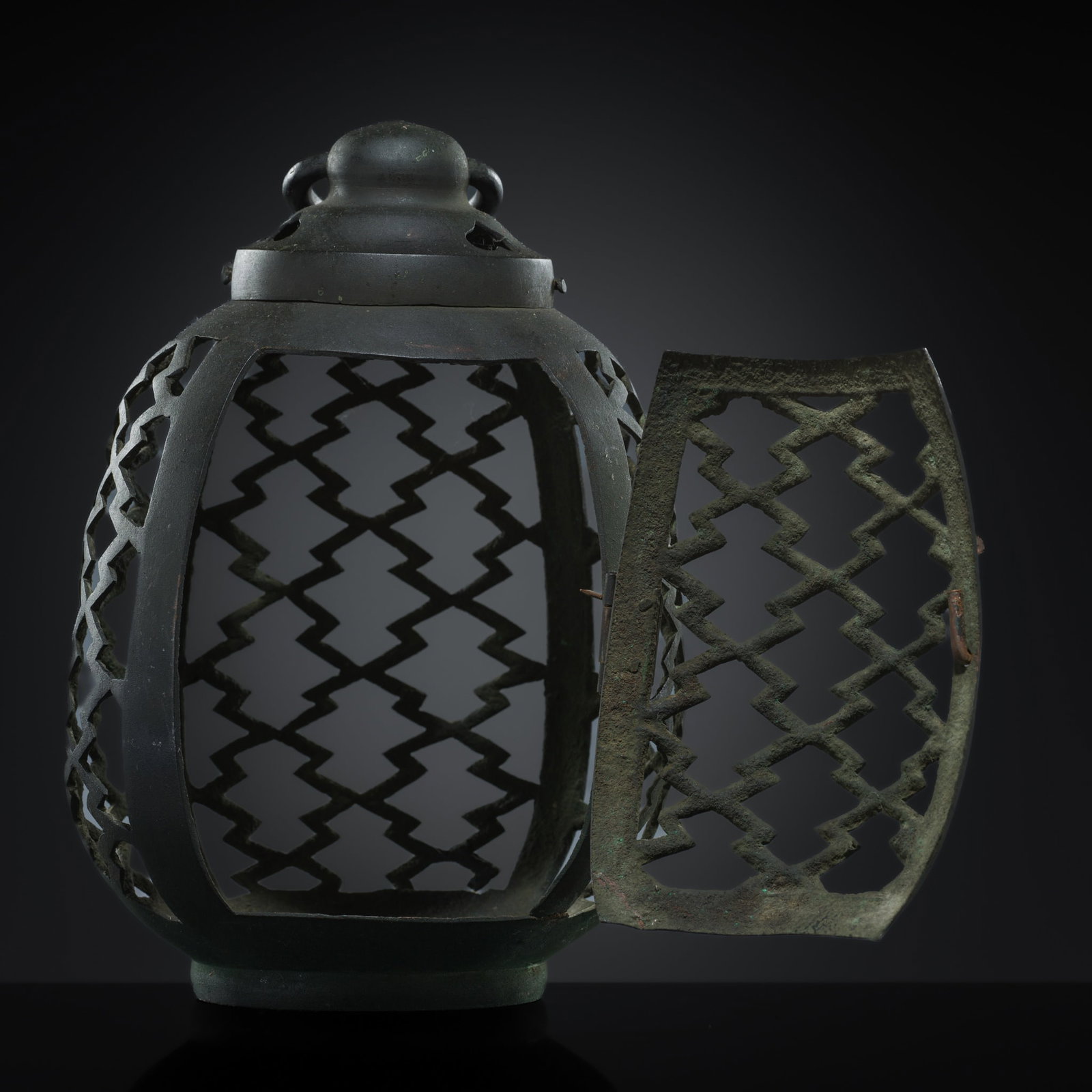 AN OPENWORK BRONZE PORTABLE LANTERN, 19TH CENTURY: AN OPENWORK BRONZE PORTABLE LANTERN, 19TH CENTURY This lot is from a single owner collection and is therefore offered without reserve The Jorgen Ruben Gallery Ledger, entry from 2005: “No. 405, 