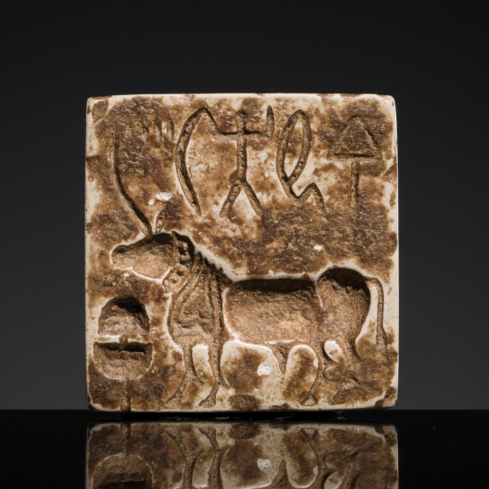 A SMALL GREY STEATITE 'UNICORN' STAMP SEAL, INDUS VALLEY CIVILIZATION, MATURE HARAPPAN: A SMALL GREY STEATITE 'UNICORN' STAMP SEAL, INDUS VALLEY CIVILIZATION, MATURE HARAPPAN This lot is from a single owner collection and is therefore offered without reserve Expert's note: The creature o