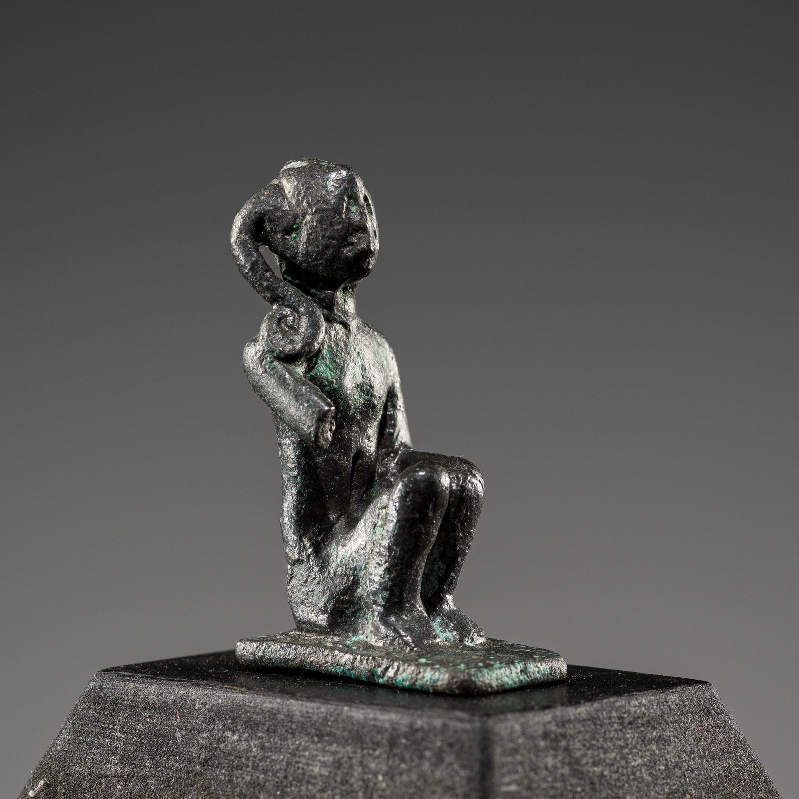 AN EGYPTIAN BRONZE FIGURE OF HARPOKRATES (HORUS THE CHILD), LATE PERIOD: AN EGYPTIAN BRONZE FIGURE OF HARPOKRATES (HORUS THE CHILD), LATE PERIOD This lot is from a single owner collection and is therefore offered without reserve Egypt, 664-332 BC. Finely cast seated on a s