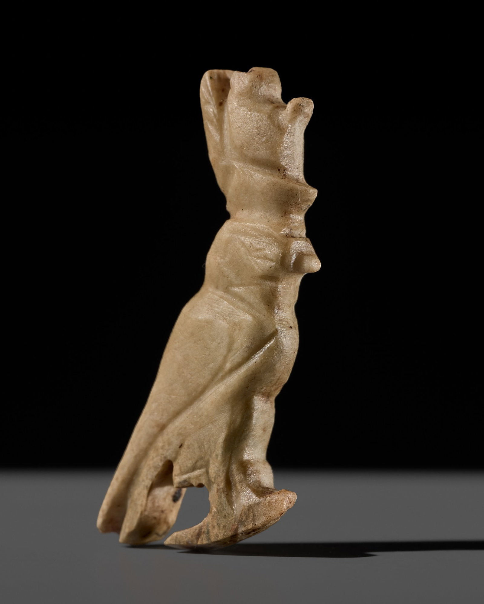 A FINE EGYPTIAN INDURATED LIMESTONE 'HORUS FALCON' AMULET, LATE PERIOD: A FINE EGYPTIAN INDURATED LIMESTONE 'HORUS FALCON' AMULET, LATE PERIOD This lot is from a single owner collection and is therefore offered without reserve The Jorgen Ruben Gallery Ledger, entry from 2