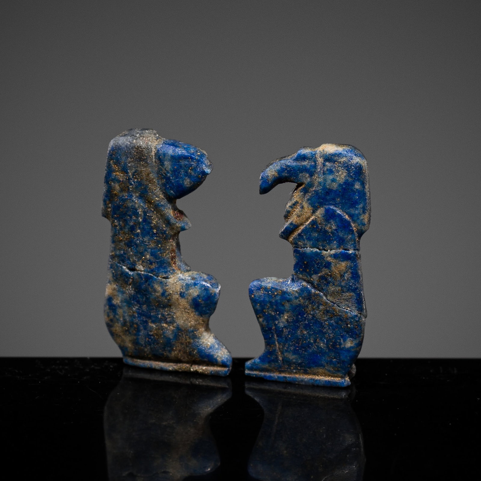 A PAIR OF EGYPTIAN LAPIS LAZULI AMULETS OF HORUS AND THOTH, NEW KINGDOM (1 of 11)