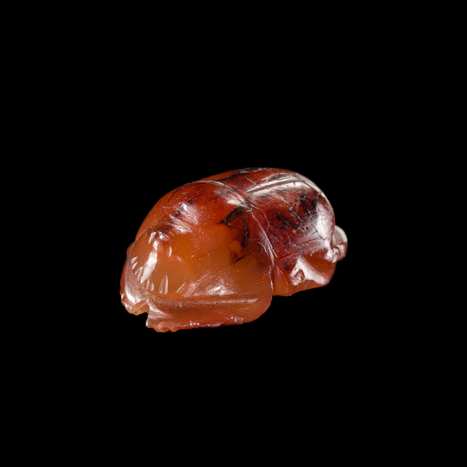 A CARNELIAN SCARAB, NEW KINGDOM: A CARNELIAN SCARAB, NEW KINGDOM This lot is from a single owner collection and is therefore offered without reserve Egypt, circa 1550-1070 BC. Naturalistically carved, the scarab depicts a dung beetle