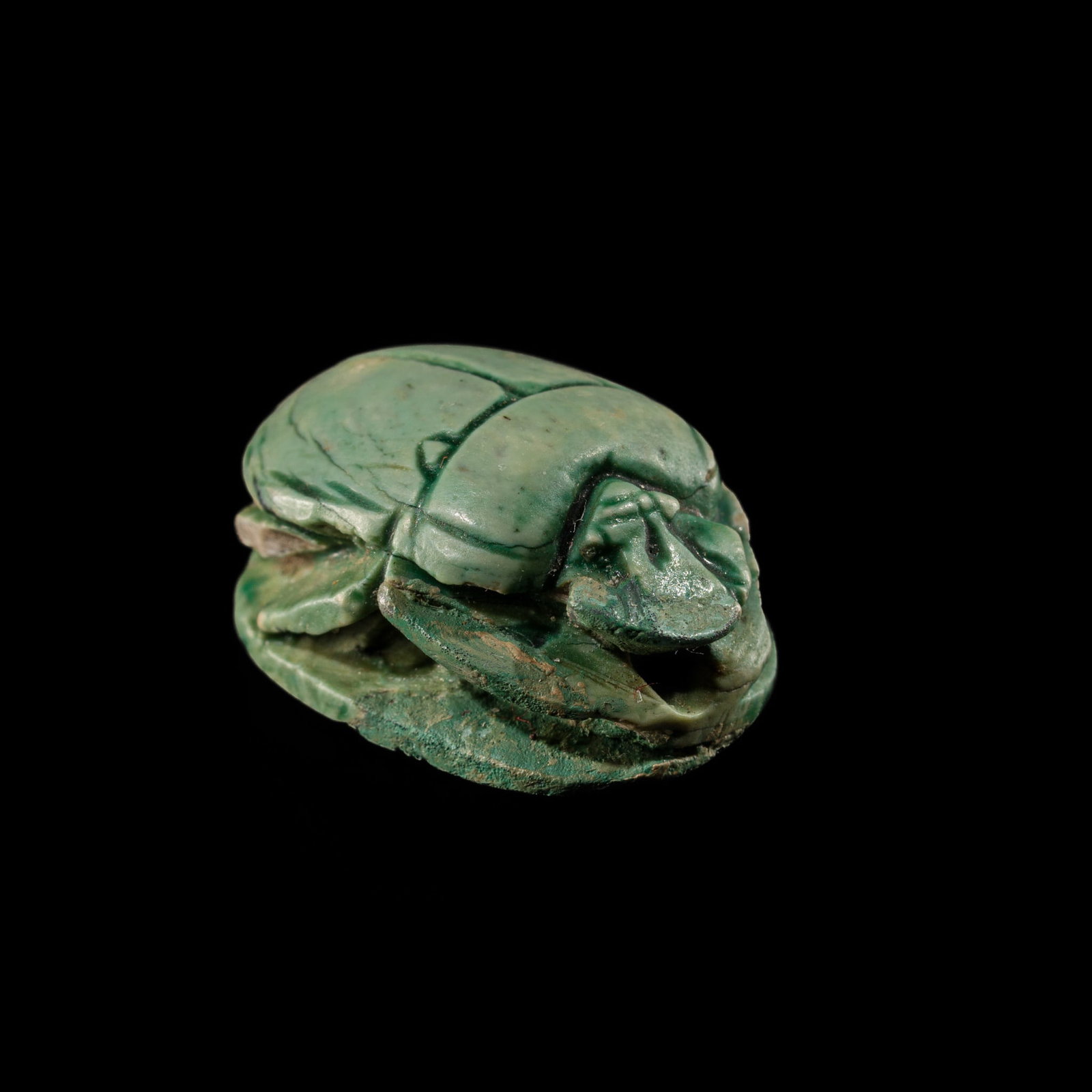 AN INSCRIBED GREEN FAIENCE SCARAB FOR THUTMOSE III, NEW KINGDOM: AN INSCRIBED GREEN FAIENCE SCARAB FOR THUTMOSE III, NEW KINGDOM This lot is from a single owner collection and is therefore offered without reserve Egypt, circa 1479-1070 BC. Naturalistically carved, 