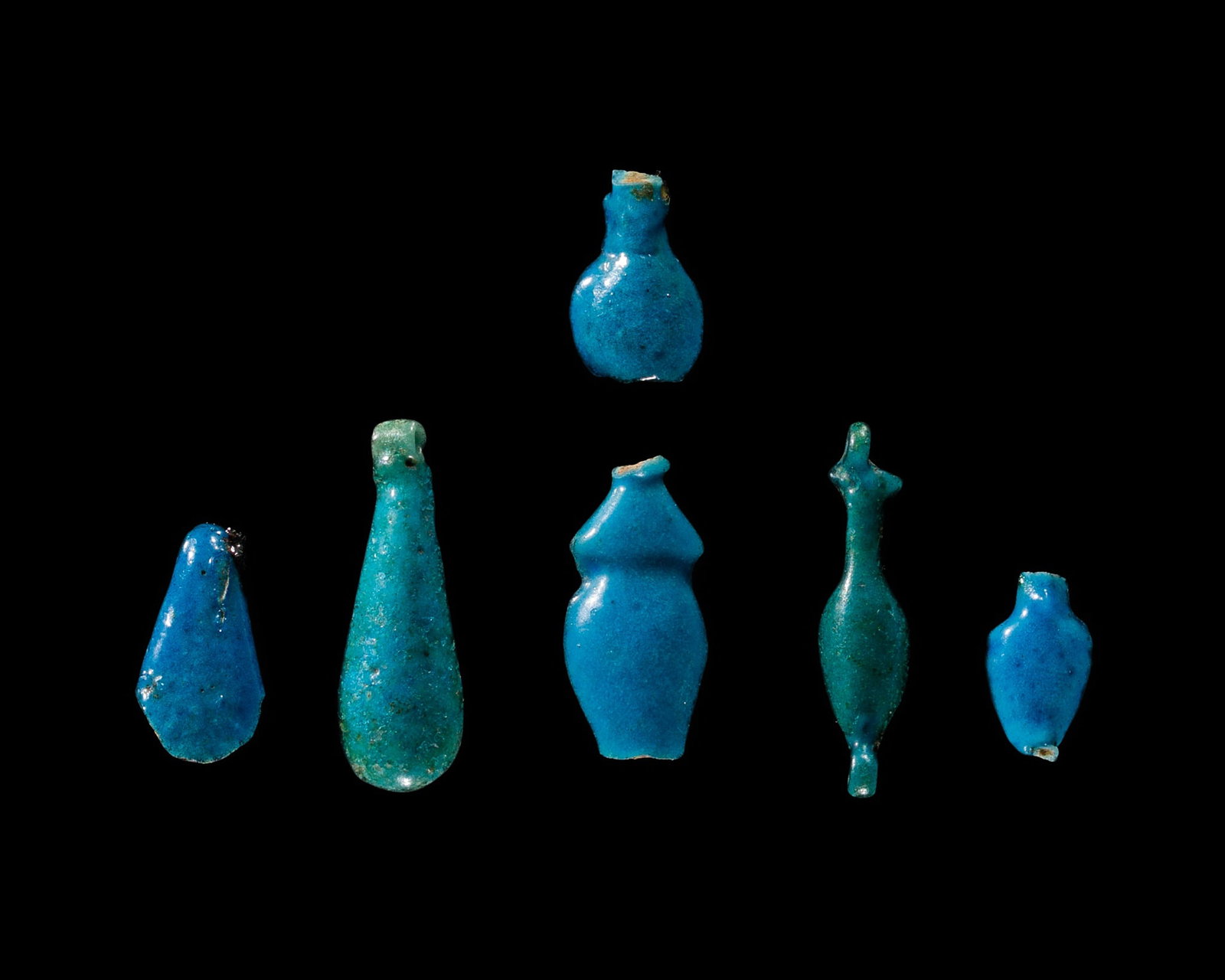 A GROUP OF SIX TURQUOISE-BLUE FAIENCE AMULETS, NEW KINGDOM, DYNASTY XVIII: A GROUP OF SIX TURQUOISE-BLUE FAIENCE AMULETS, NEW KINGDOM, DYNASTY XVIII This lot is from a single owner collection and is therefore offered without reserve Egypt, 1550-1292 BC. Comprising six faienc