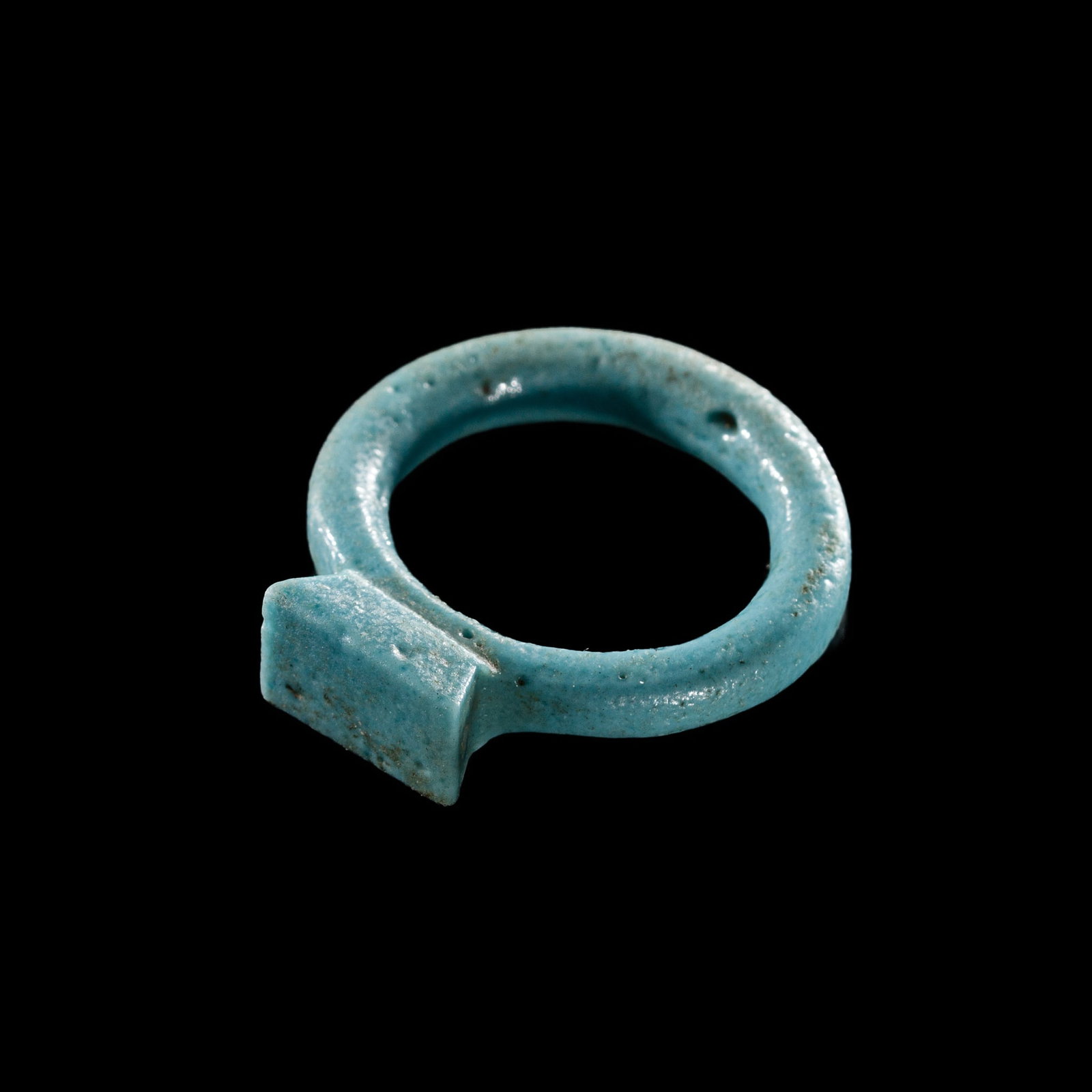 A TURQUOISE FAIENCE RING, NEW KINGDOM, DYNASTY XVIII: A TURQUOISE FAIENCE RING, NEW KINGDOM, DYNASTY XVIII This lot is from a single owner collection and is therefore offered without reserve The Jorgen Ruben Gallery Ledger, entry from 2005: “No. 51