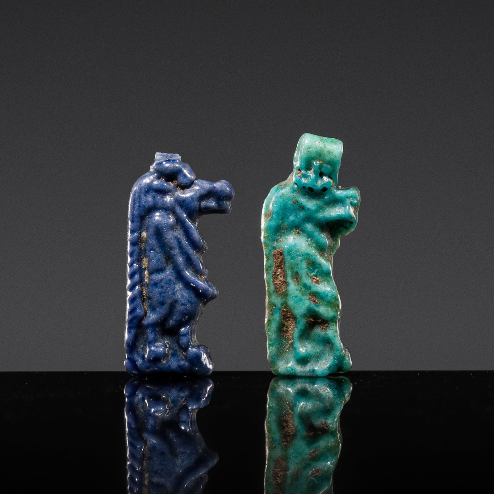 A GROUP OF TWO FAIENCE 'TAWERET' MINIATURE AMULETS, NEW KINGDOM, DYNASTY XVIII: A GROUP OF TWO FAIENCE 'TAWERET' MINIATURE AMULETS, NEW KINGDOM, DYNASTY XVIII This lot is from a single owner collection and is therefore offered without reserve Egypt, circa 1550-1295 BC. Combining 