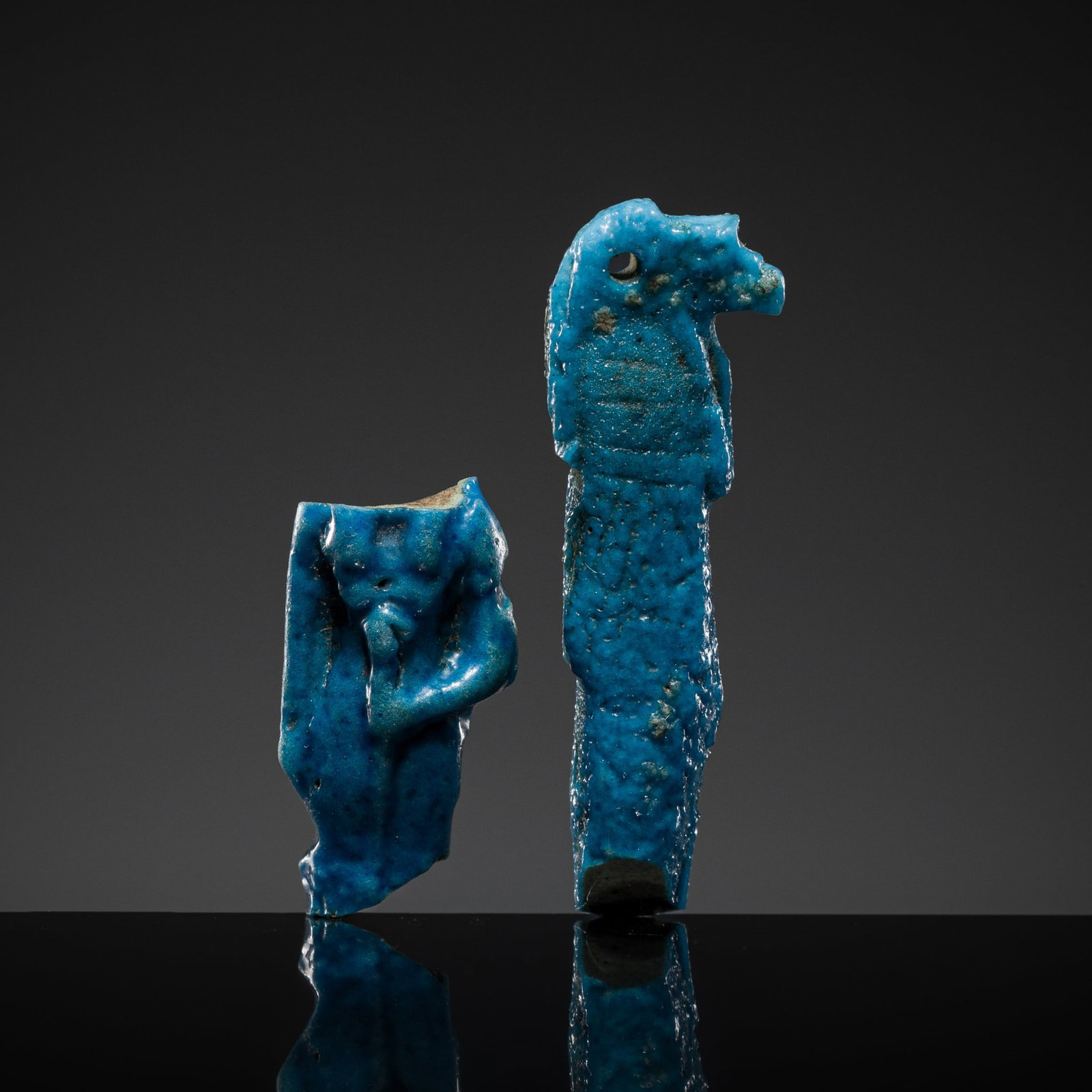 A GROUP OF TWO BLUE FAIENCE AMULETS OF SEKHMET AND DUAMUTEF, LATE PERIOD: A GROUP OF TWO BLUE FAIENCE AMULETS OF SEKHMET AND DUAMUTEF, LATE PERIOD This lot is from a single owner collection and is therefore offered without reserve The Jorgen Ruben Gallery Ledger, entry from