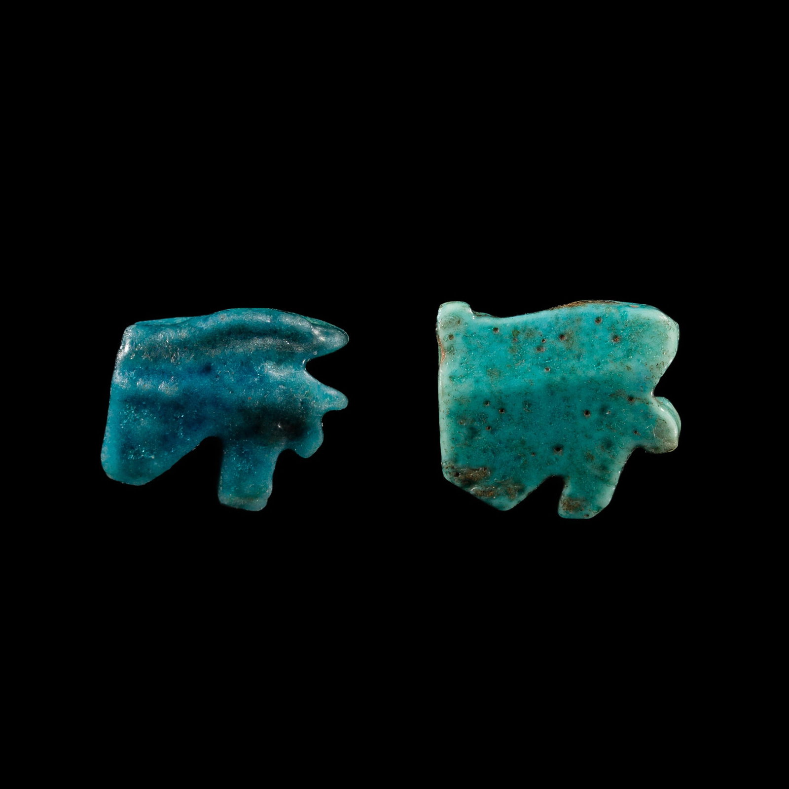 TWO MINIATURE FAIENCE WEDJAT-EYE AMULETS, LATE PERIOD: TWO MINIATURE FAIENCE WEDJAT-EYE AMULETS, LATE PERIOD This lot is from a single owner collection and is therefore offered without reserve Egypt, 664-332 BC. Each finely modeled in the form of the left