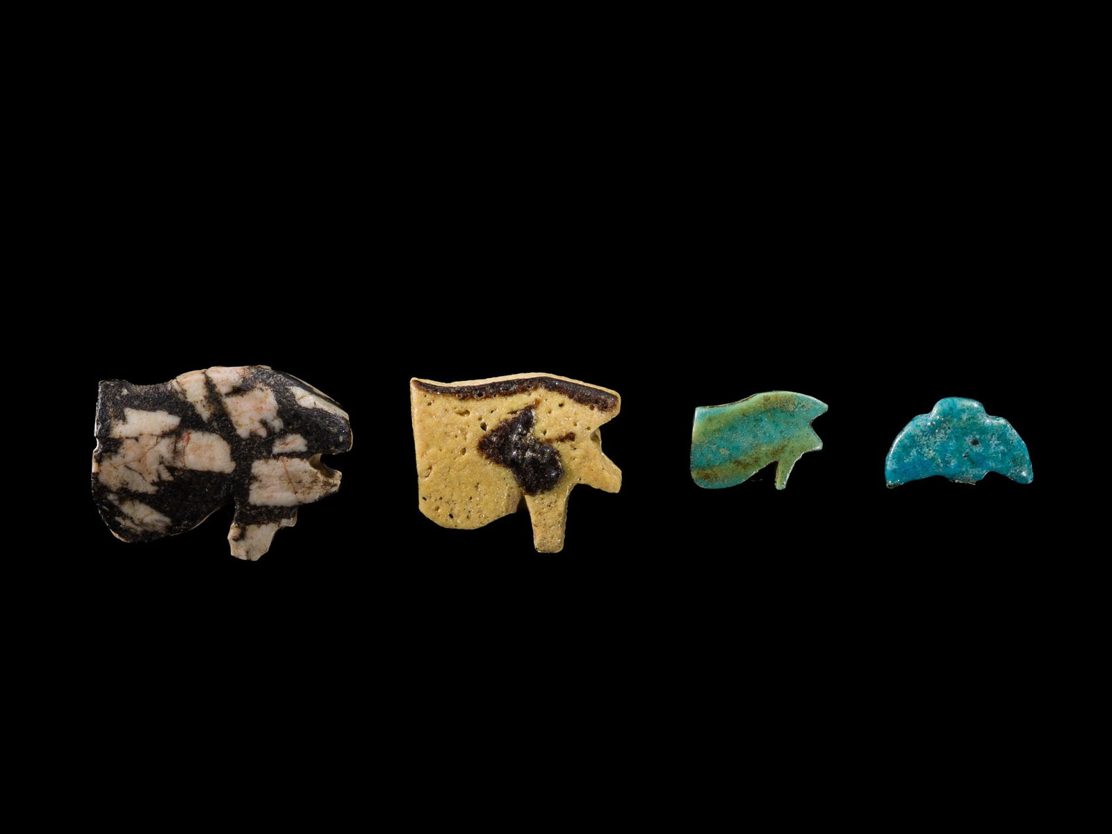 A GROUP OF FOUR EGYPTIAN GLASS AND FAIENCE 'WEDJAT EYES AND BIRD' BEADS, LATE PERIOD-PTOLEMAIC: A GROUP OF FOUR EGYPTIAN GLASS AND FAIENCE 'WEDJAT EYES AND BIRD' BEADS, LATE PERIOD-PTOLEMAIC PERIOD This lot is from a single owner collection and is therefore offered without reserve Egypt, 664-332