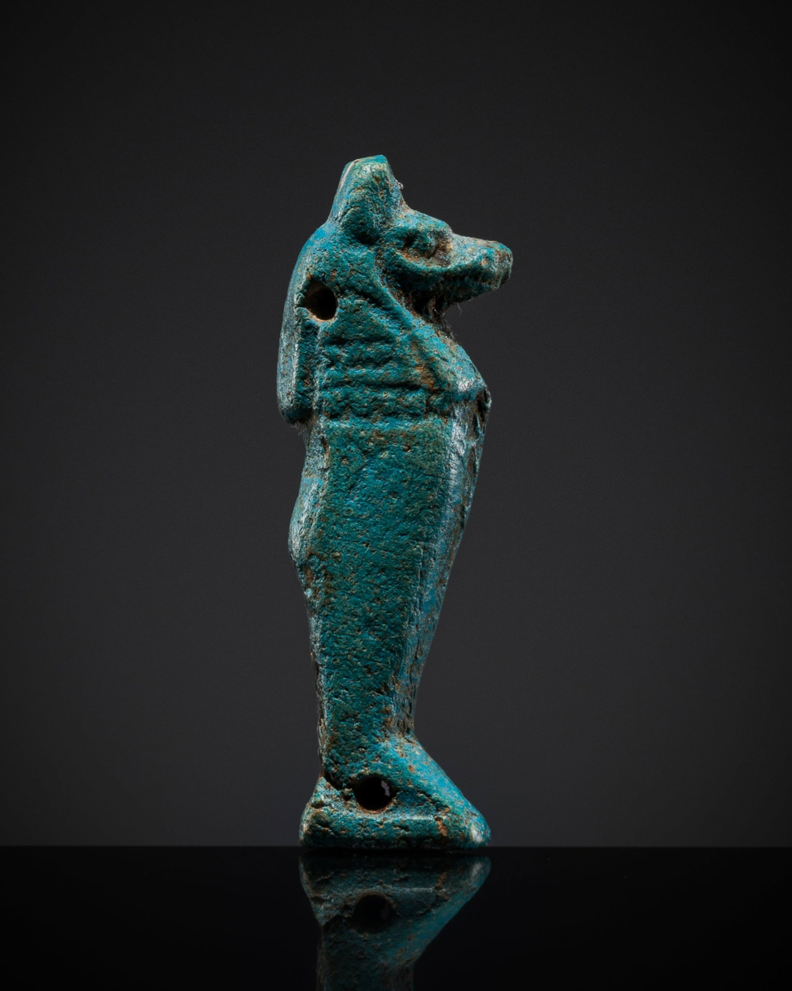 A TURQUOISE FAIENCE AMULET OF DUAMUTEF, THIRD INTERMEDIATE PERIOD-LATE PERIOD: A TURQUOISE FAIENCE AMULET OF DUAMUTEF, THIRD INTERMEDIATE PERIOD-LATE PERIOD This lot is from a single owner collection and is therefore offered without reserve Egypt, 1070-525 BC. Carved in the form