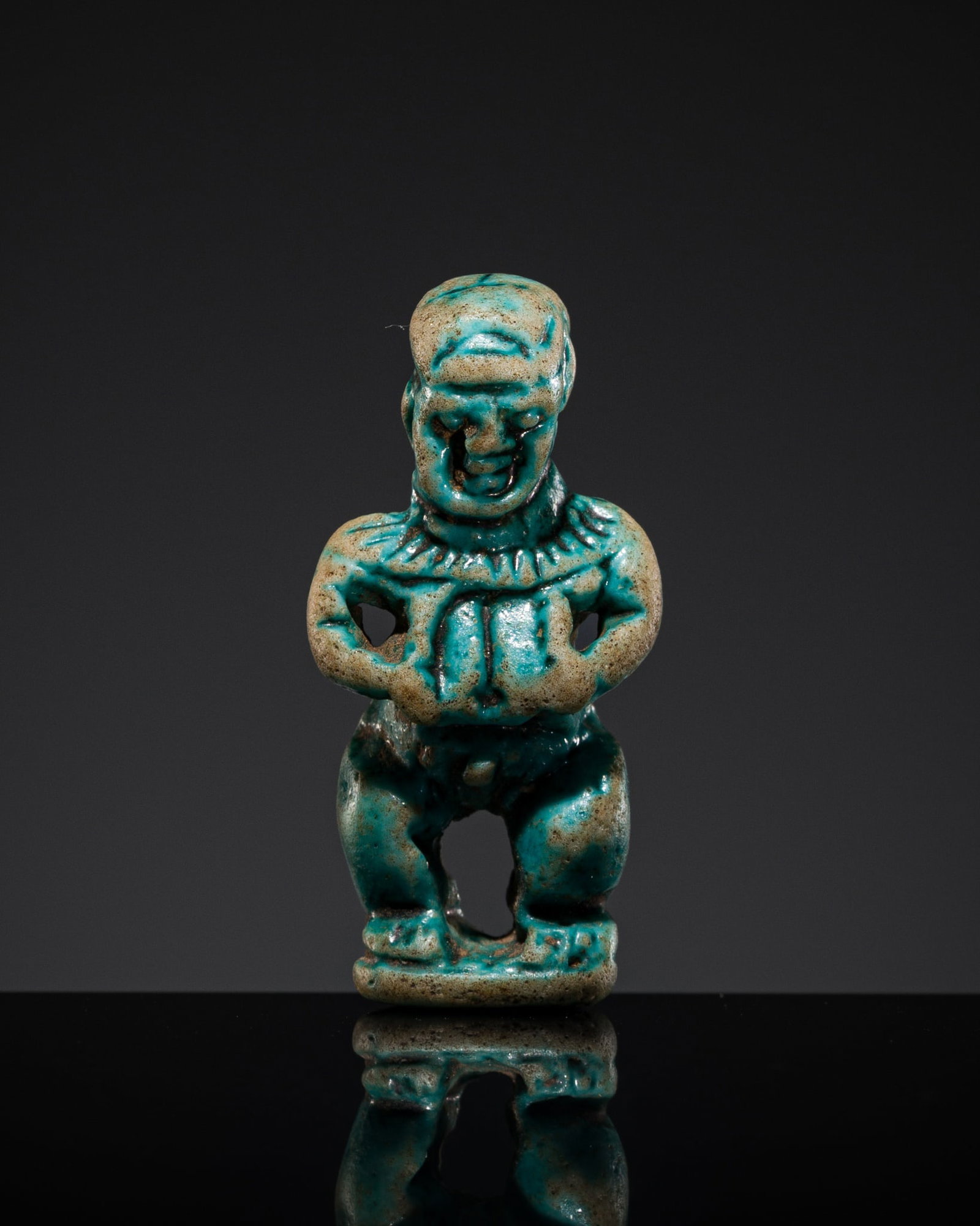 A TURQUOISE FAIENCE AMULET OF PATAIKOS, THIRD INTERMEDIATE PERIOD-LATE PERIOD (1 of 11)