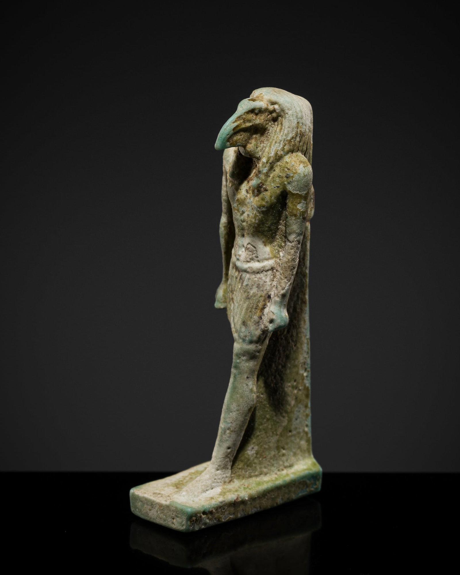 A TURQUOISE FAIENCE AMULET OF THOTH, LATE PERIOD: A TURQUOISE FAIENCE AMULET OF THOTH, LATE PERIOD This lot is from a single owner collection and is therefore offered without reserve The Jorgen Ruben Gallery Ledger, entry from 2012: “No. 732, A