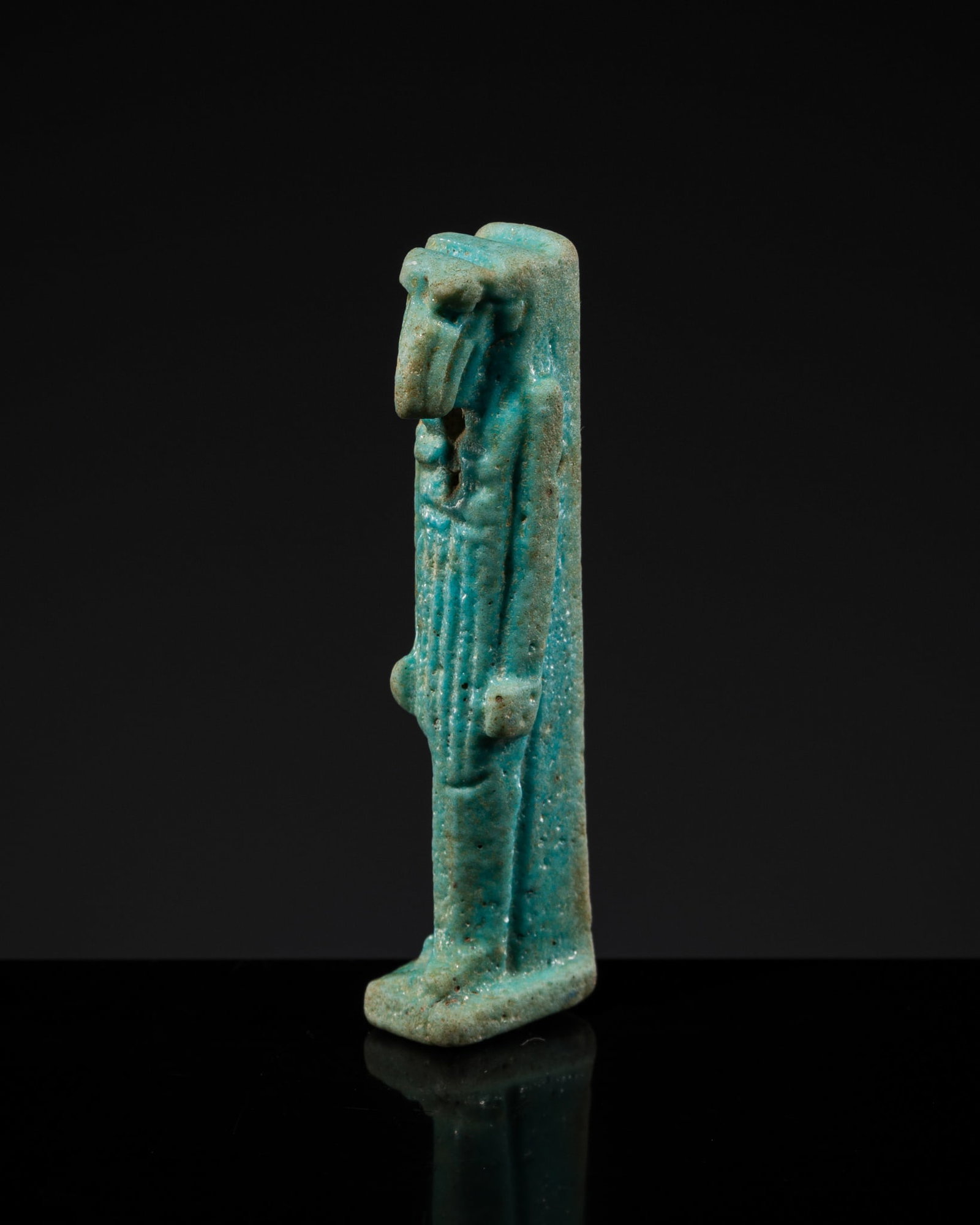 A TURQUOISE FAIENCE THOTH AMULET, LATE PERIOD: A TURQUOISE FAIENCE THOTH AMULET, LATE PERIOD This lot is from a single owner collection and is therefore offered without reserve Egypt, 664-332 BC. Skillfully modelled, the anthropomorphic figure dep