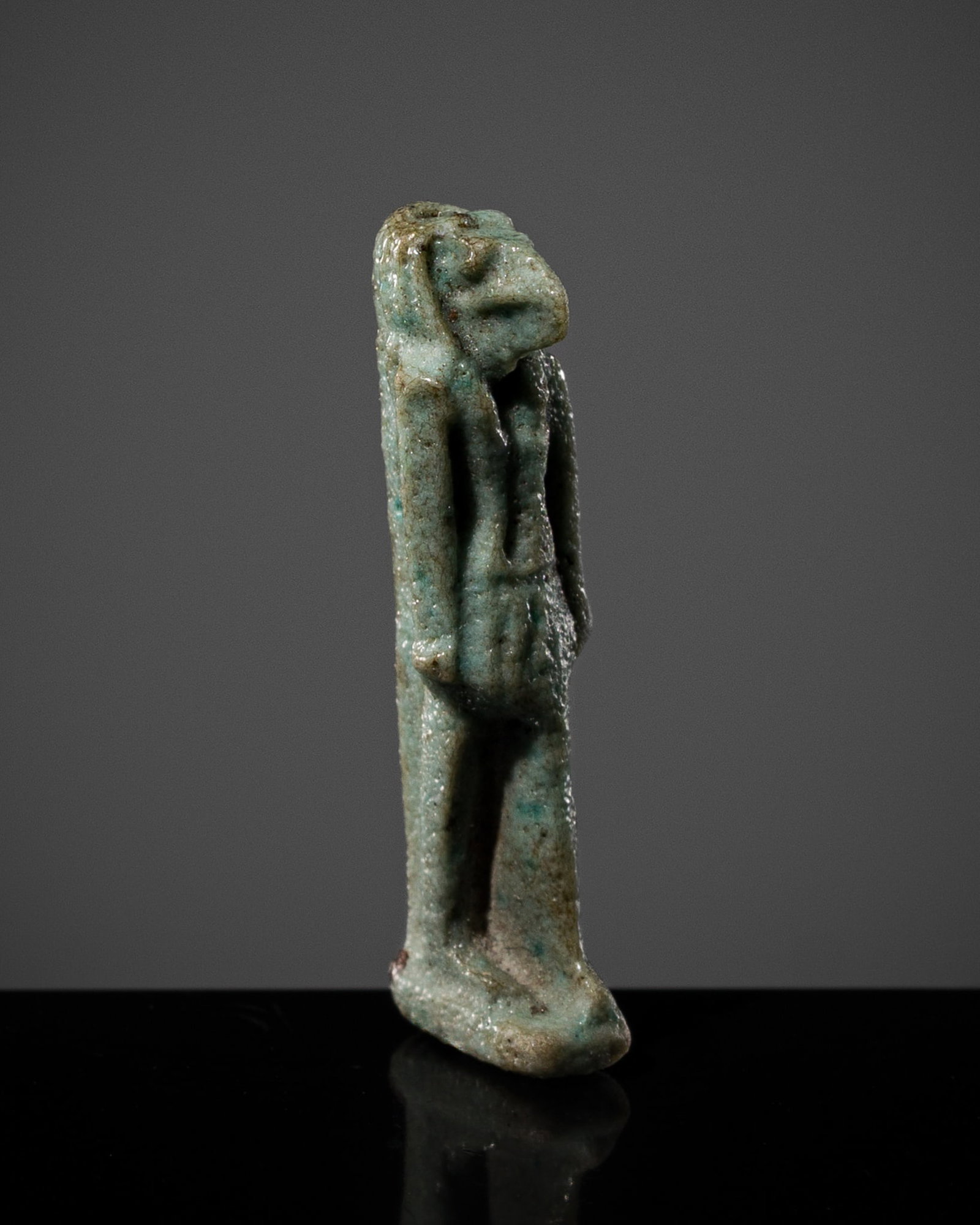 A TURQUOISE FAIENCE AMULET OF THOTH, LATE PERIOD: A TURQUOISE FAIENCE AMULET OF THOTH, LATE PERIOD This lot is from a single owner collection and is therefore offered without reserve Egypt, 664-30 BC. Skillfully modelled, the anthropomorphic figure d
