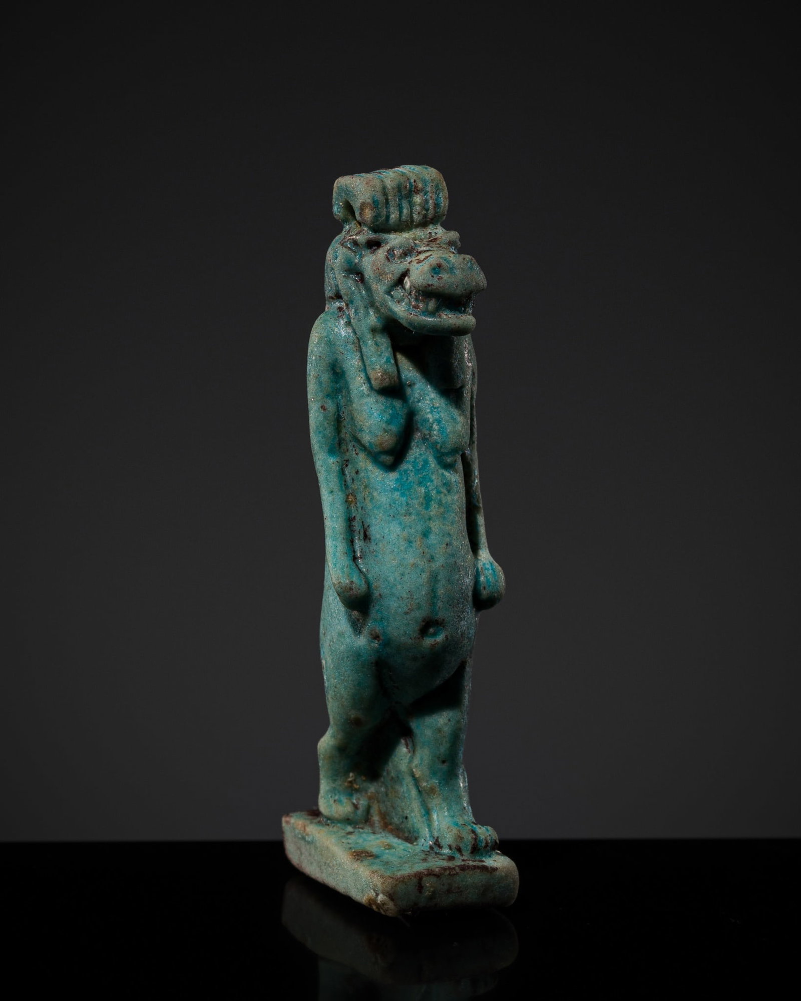 A TURQUOISE FAIENCE AMULET OF TAWERET, LATE PERIOD: A TURQUOISE FAIENCE AMULET OF TAWERET, LATE PERIOD This lot is from a single owner collection and is therefore offered without reserve Egypt, 664-332 BC. Finely modeled, the anthropomorphic deity stan