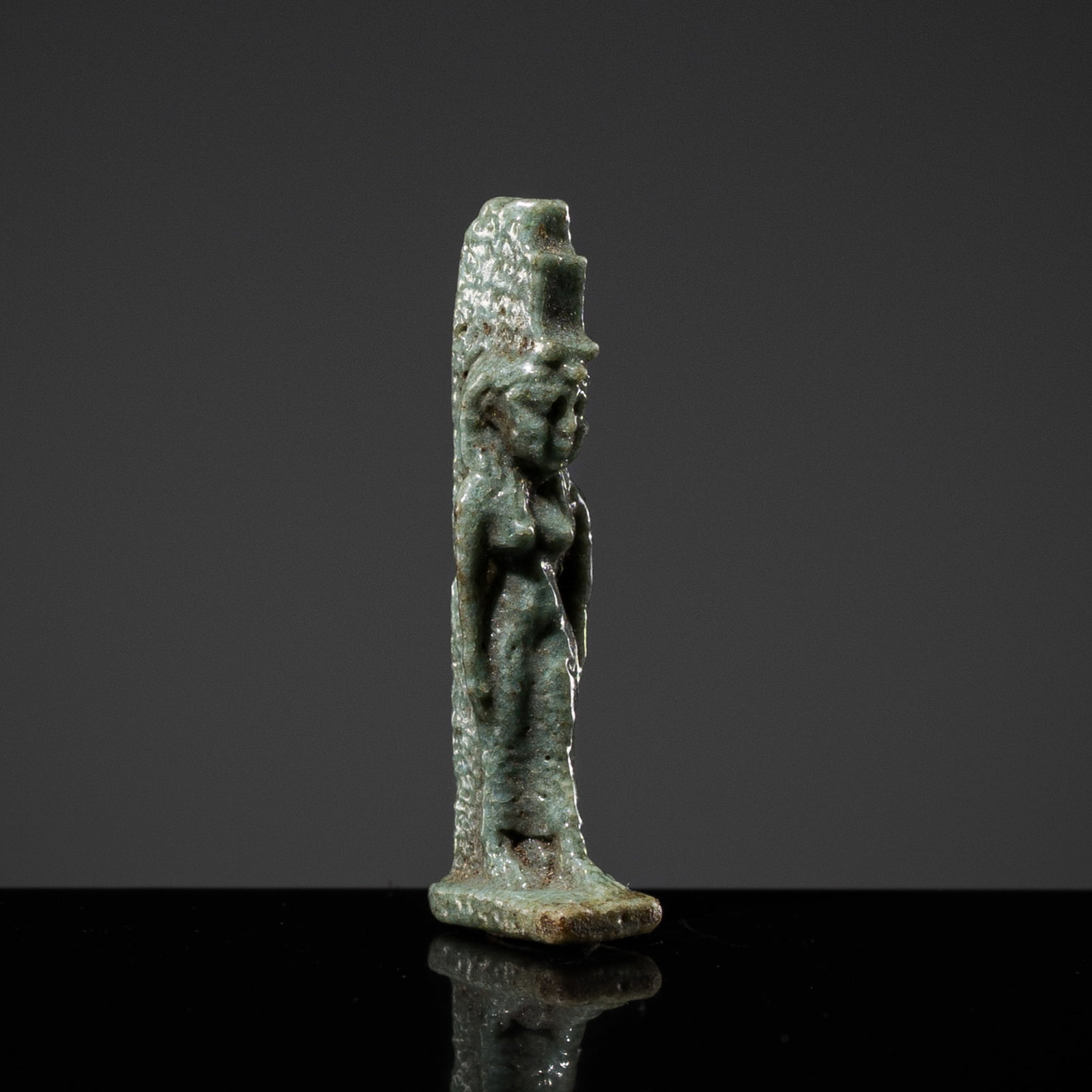 A FINE MINIATURE GREEN FAIENCE AMULET OF ISIS, LATE PERIOD (1 of 13)