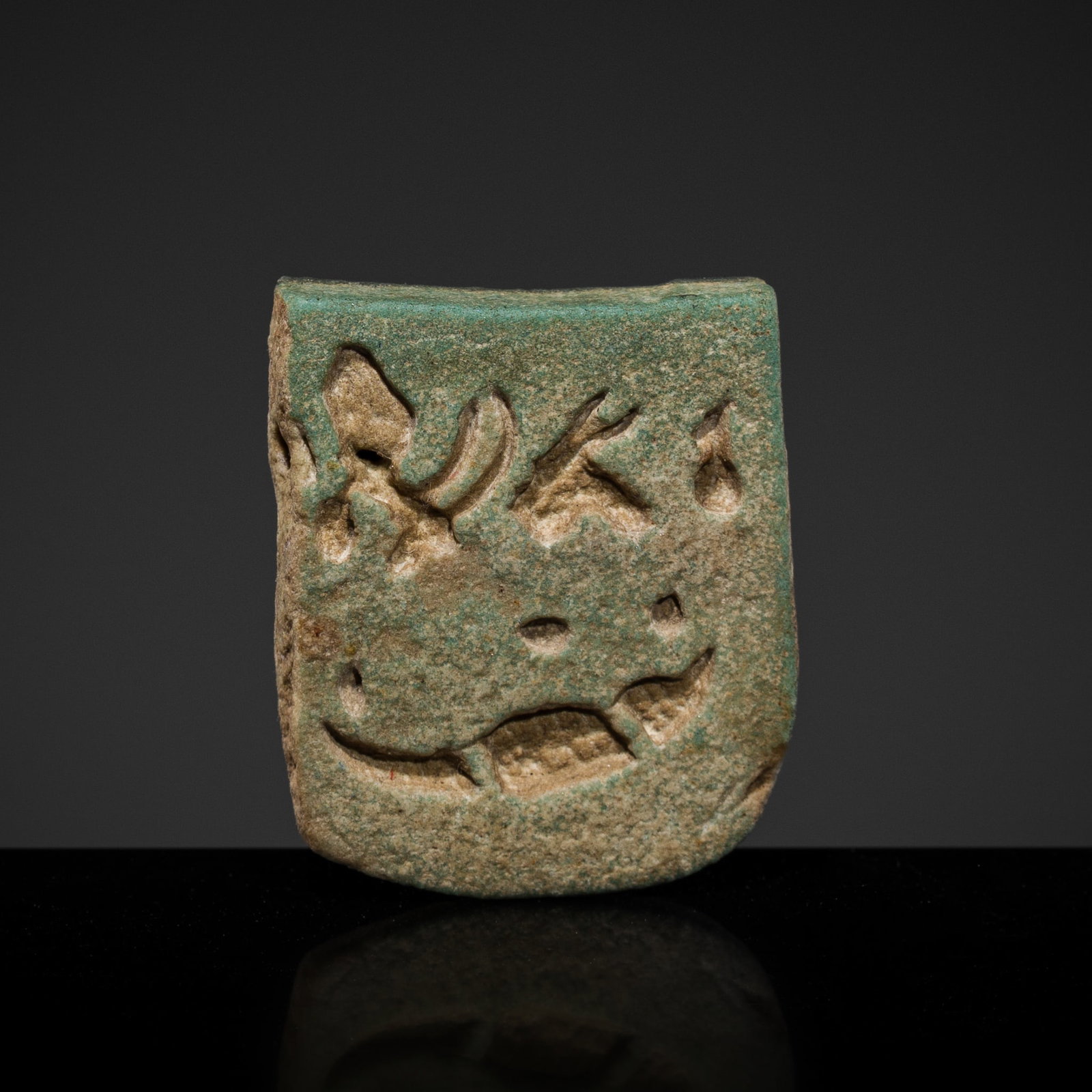 A RARE GREEN FAIENCE MINIATURE PECTORAL FOR SOBEK, LATE PERIOD: A RARE GREEN FAIENCE MINIATURE PECTORAL FOR SOBEK, LATE PERIOD This lot is from a single owner collection and is therefore offered without reserve The Jorgen Ruben Gallery Ledger, entry from 2005: 