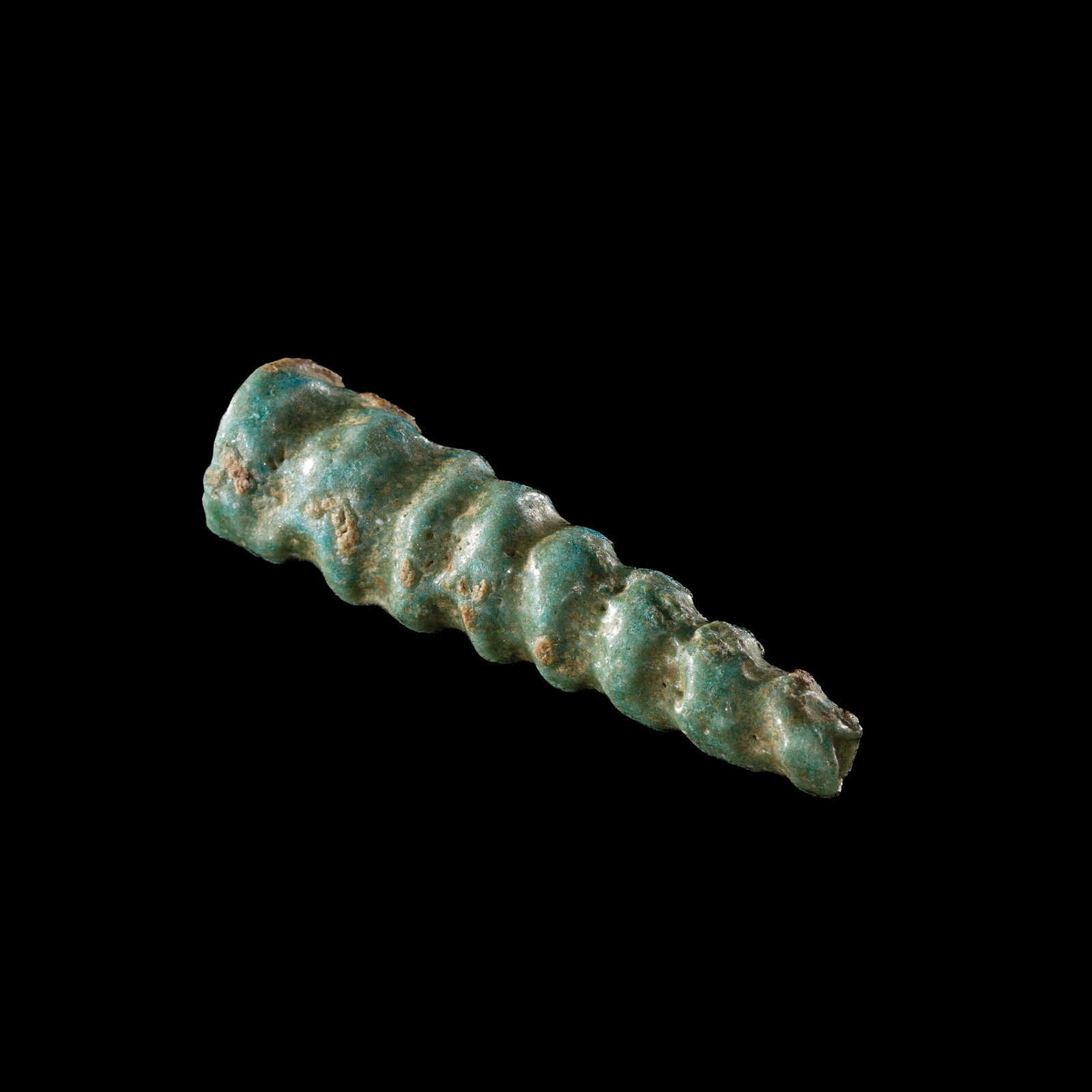 A RARE TURQUOISE FAIENCE 'SPIRAL SHELL' AMULET, LATE PERIOD: A RARE TURQUOISE FAIENCE 'SPIRAL SHELL' AMULET, LATE PERIOD This lot is from a single owner collection and is therefore offered without reserve Egypt, 664-332 BC. Well modeled as a tapering gastropod 