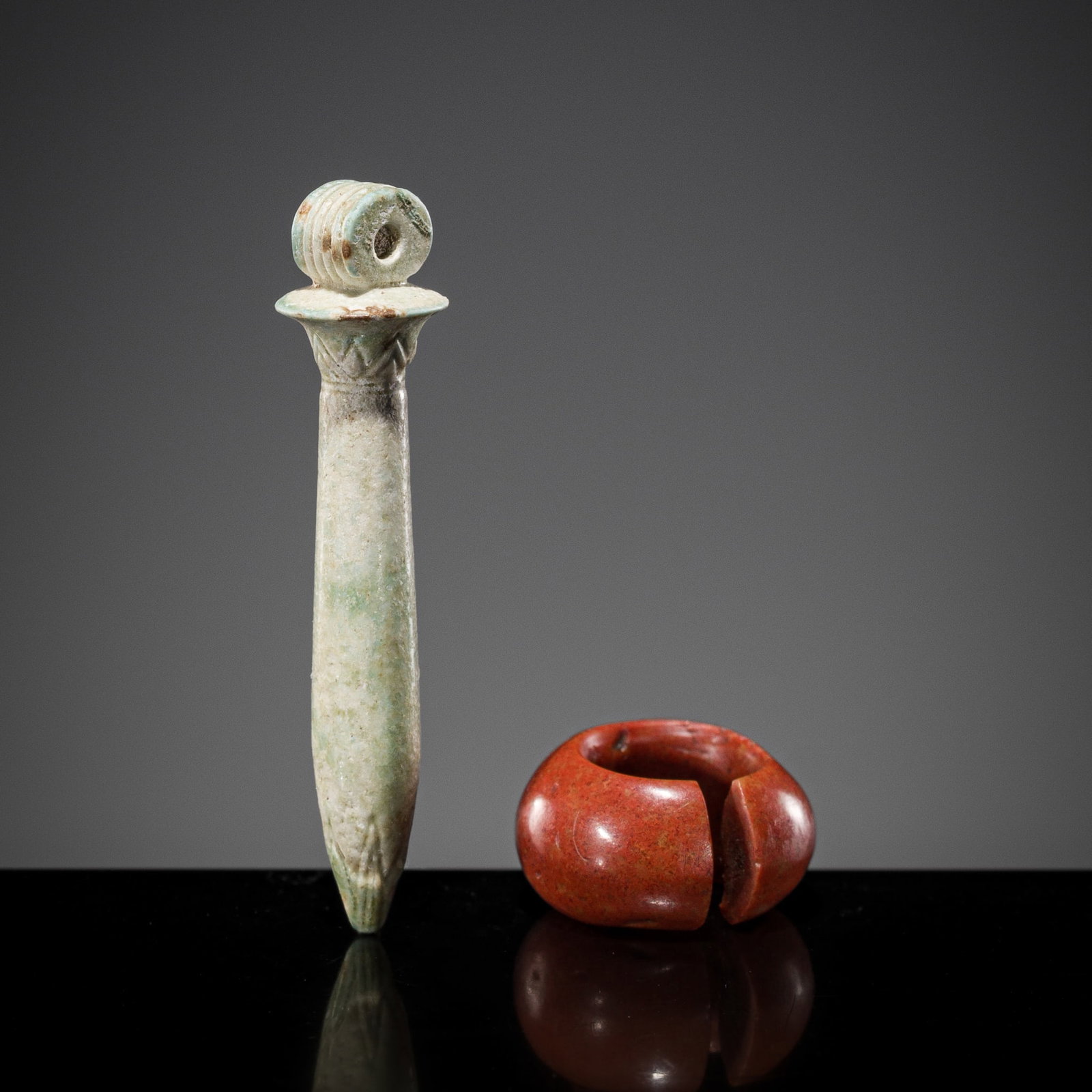 AN EGYPTIAN FAIENCE 'PAPYRUS COLUMN' AMULET AND A JASPER PENANNULAR HAIR RING, LATE PERIOD OR (1 of 9)