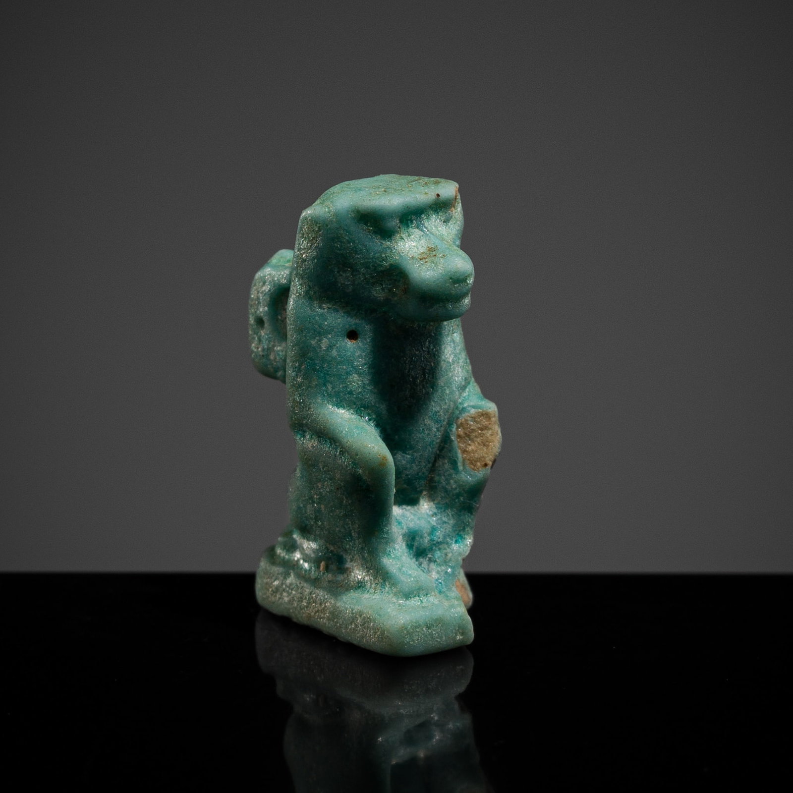 A TURQUOISE FAIENCE 'BABOON' AMULET, LATE PERIOD-PTOLEMAIC PERIOD (1 of 11)
