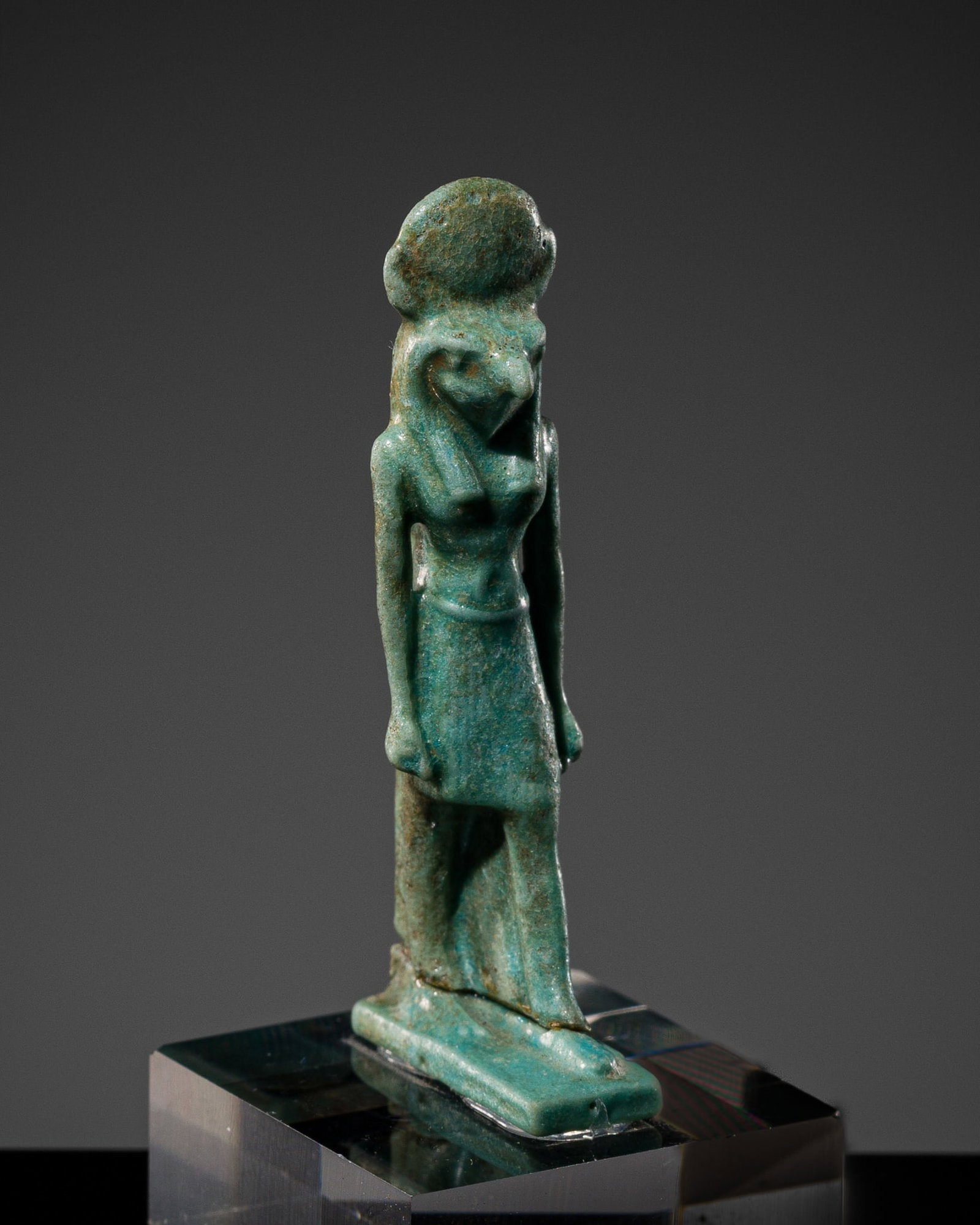 A TURQUOISE FAIENCE AMULET OF RE-HORAKHTY, LATE PERIOD-PTOLEMAIC PERIOD (1 of 10)