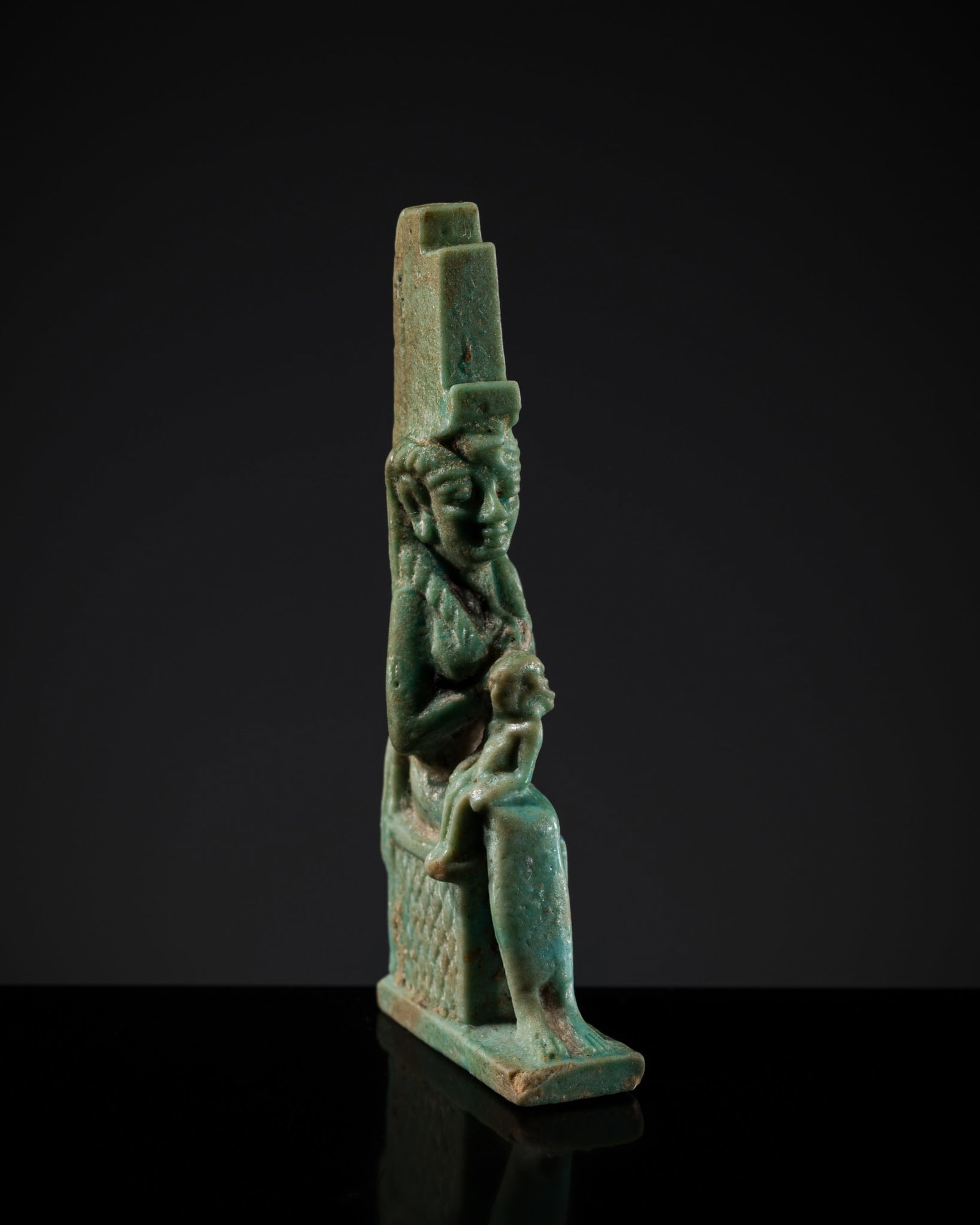A TURQUOISE FAIENCE FIGURE OF ISIS NURSING HORUS, LATE PERIOD-PTOLEMAIC PERIOD: A TURQUOISE FAIENCE FIGURE OF ISIS NURSING HORUS, LATE PERIOD-PTOLEMAIC PERIOD This lot is from a single owner collection and is therefore offered without reserve The Jorgen Ruben Gallery Ledger, entr