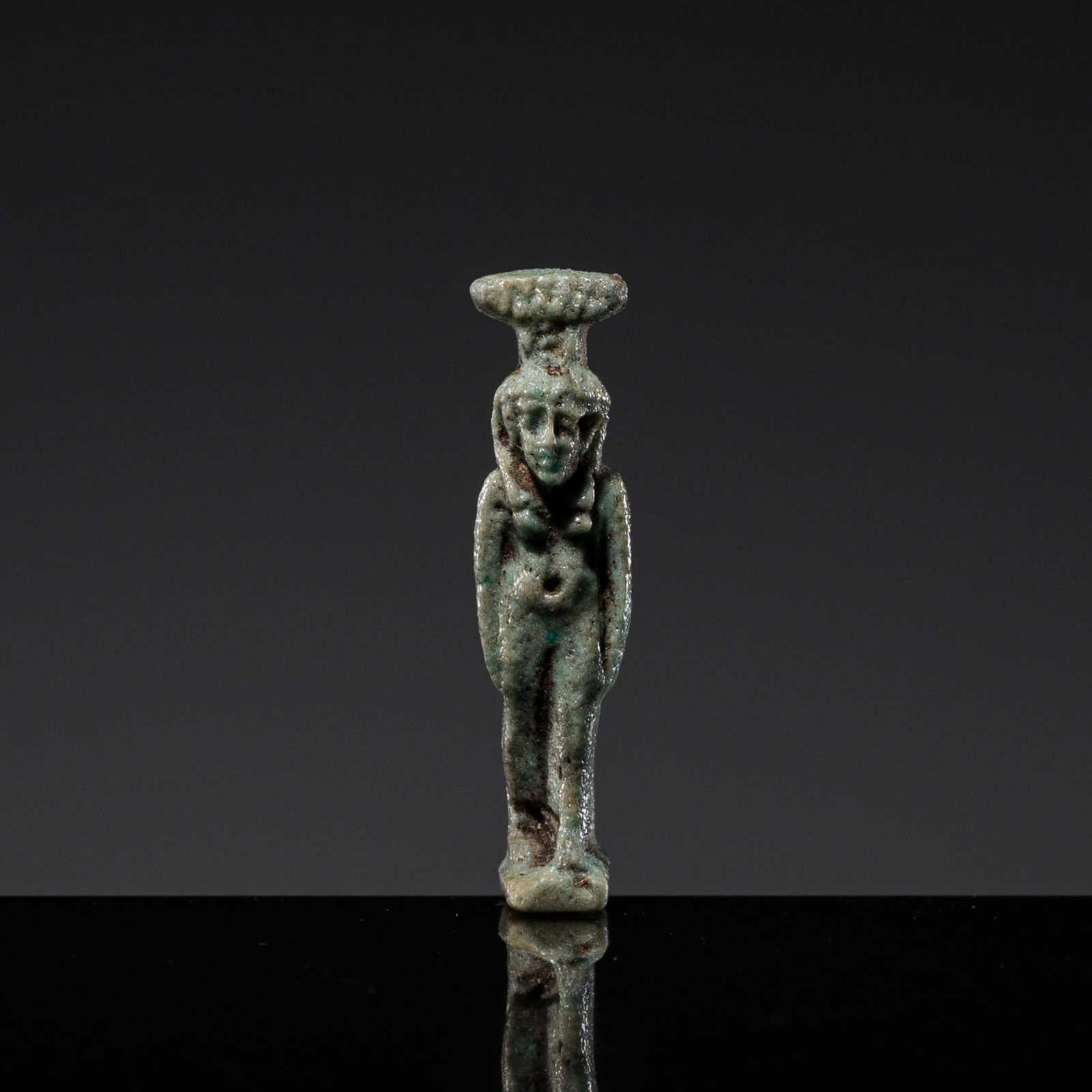 A TURQUOISE GLAZED FAIENCE AMULET OF NEPHTHYS, LATE PERIOD: A TURQUOISE GLAZED FAIENCE AMULET OF NEPHTHYS, LATE PERIOD This lot is from a single owner collection and is therefore offered without reserve Egypt, c. 664-332 BC. Finely modeled, the female deity de