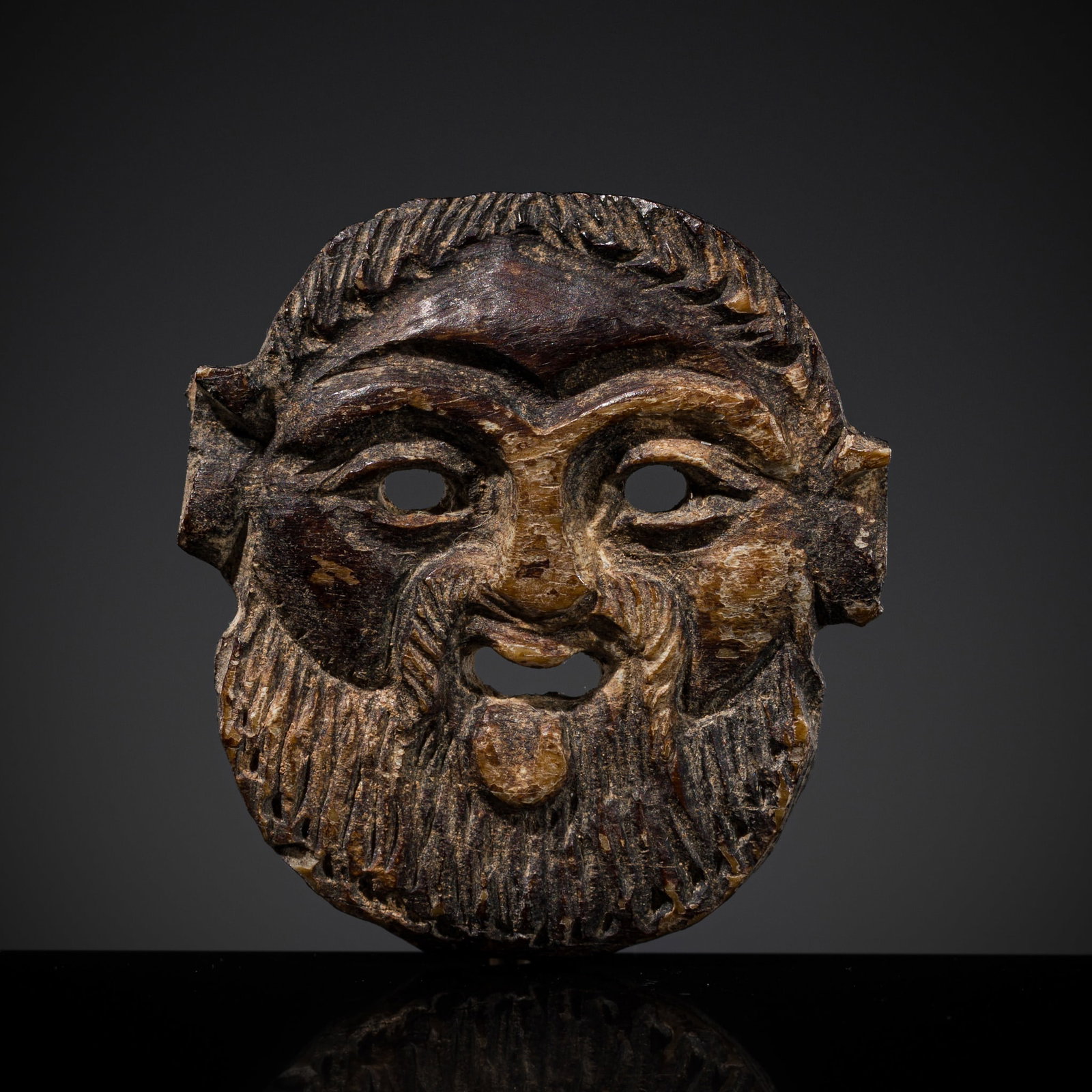 A GREEK MINIATURE BONE RITUAL MASK OF A SATYR, CIRCA 5TH CENTURY BC (1 of 11)