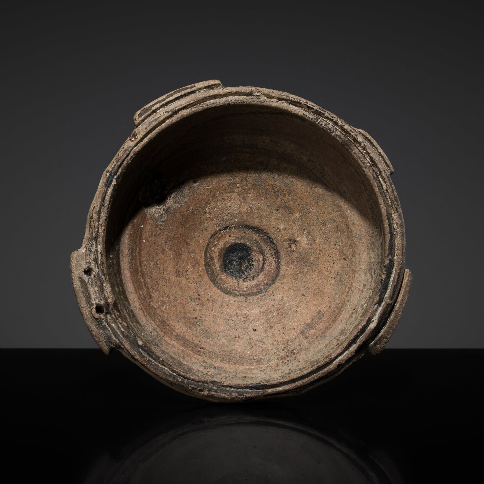 A CYPRIOT PAINTED TERRACOTTA DISH, FIRST MILLENNIUM BC: A CYPRIOT PAINTED TERRACOTTA DISH, FIRST MILLENNIUM BC This lot is from a single owner collection and is therefore offered without reserve Cyprus. Of circular form, rising from a recessed foot rim to 