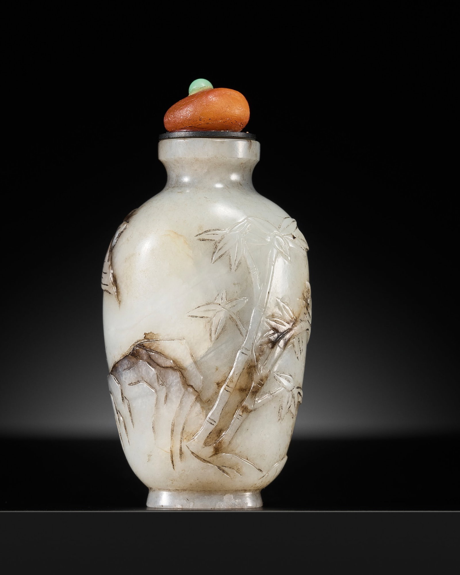 A GRAY AND BLACK JADE 'BAMBOO AND ASTER' SNUFF BOTTLE, 18TH-19TH CENTURY: A GRAY AND BLACK JADE 'BAMBOO AND ASTER' SNUFF BOTTLE, 18TH-19TH CENTURY China. Of ovoid form rising from a slightly splayed oval foot to a waisted neck with concave lip, neatly carved and incised to 