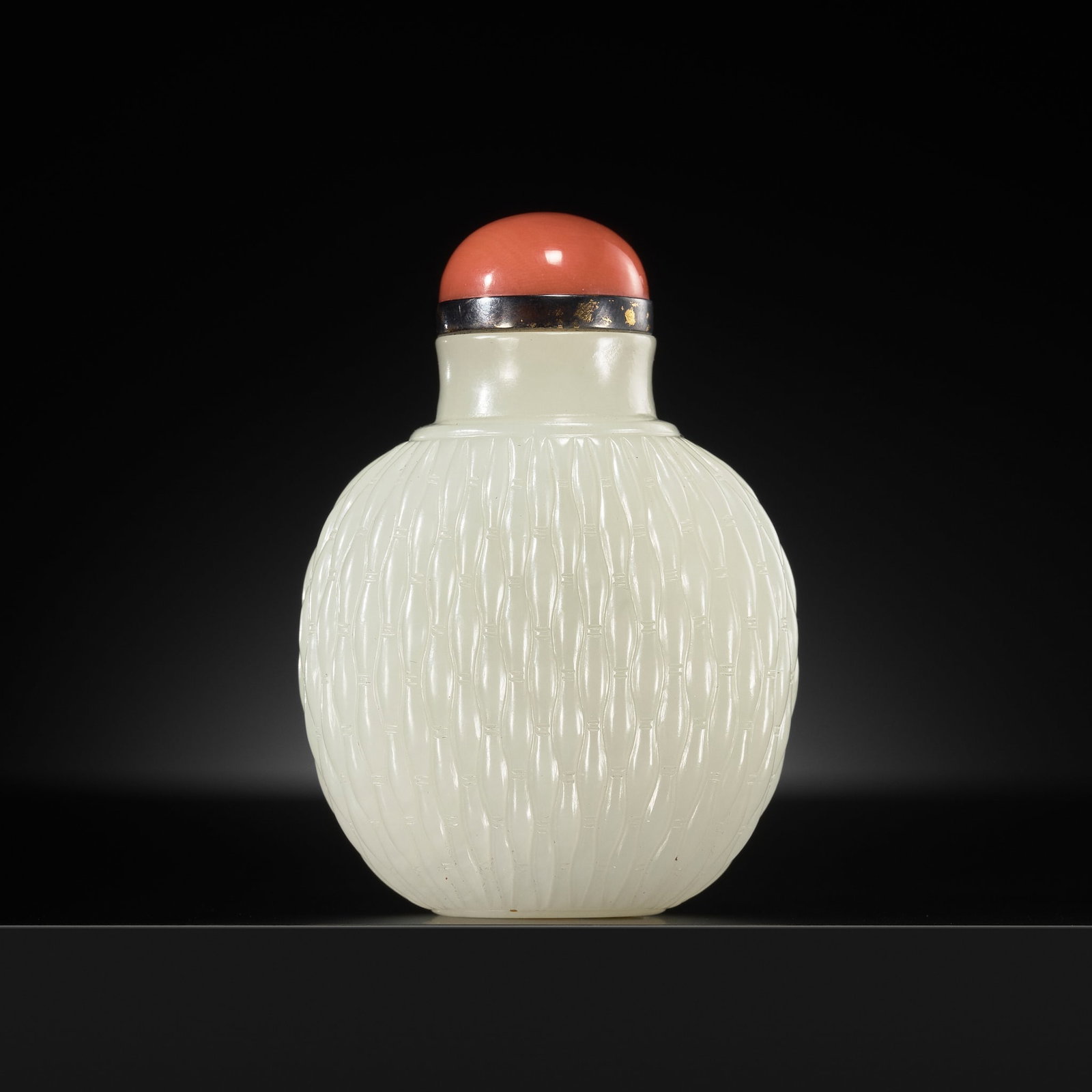A PRISTINE WHITE JADE 'BASKET' SNUFF BOTTLE, 1750-1850: A PRISTINE WHITE JADE 'BASKET' SNUFF BOTTLE, 1750-1850 China. Well hollowed, of compressed globular form, rising from a shallow oval foot to a slightly waisted neck with flat mouth, skillfully worked 