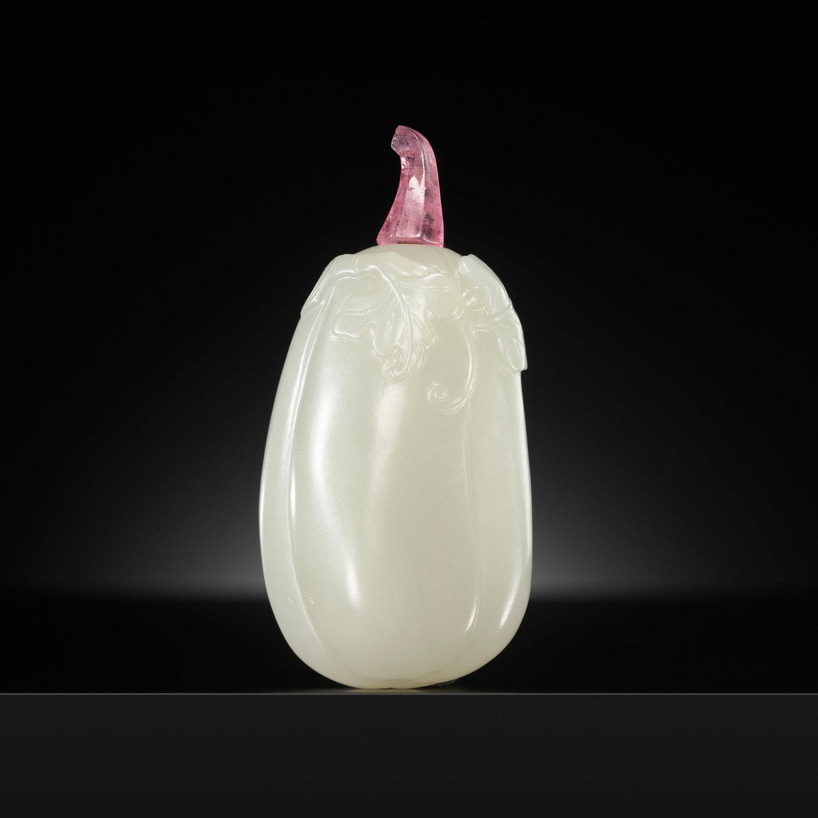 A WHITE JADE 'GOURD' SNUFF BOTTLE, 1750-1850: A WHITE JADE 'GOURD' SNUFF BOTTLE, 1750-1850 China. Very well hollowed and finely carved in the shape of an elongated gourd growing from leafage adorning the body in relief. The semi-translucent stone