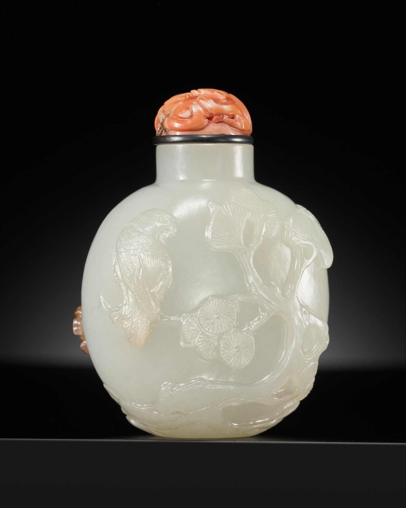 A RUSSET AND WHITE JADE 'EAGLES' SNUFF BOTTLE, 1770-1850: A RUSSET AND WHITE JADE 'EAGLES' SNUFF BOTTLE, 1770-1850 China. Well hollowed, of flattened ovoid form, rising from a concave foot to a cylindrical neck with flat lip, one side carved through the russ