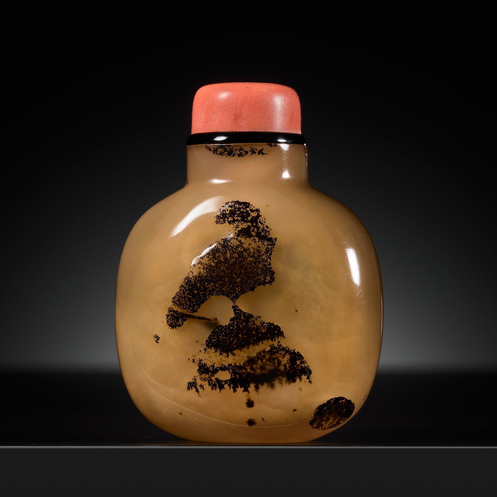A SHADOW AGATE 'HAWK ON ROCK' SNUFF BOTTLE, 1750-1850: A SHADOW AGATE 'HAWK ON ROCK' SNUFF BOTTLE, 1750-1850 China. Well hollowed, of rounded square form standing on a concave foot, with a cylindrical neck and a flat rim, sparingly carved to enhance the d