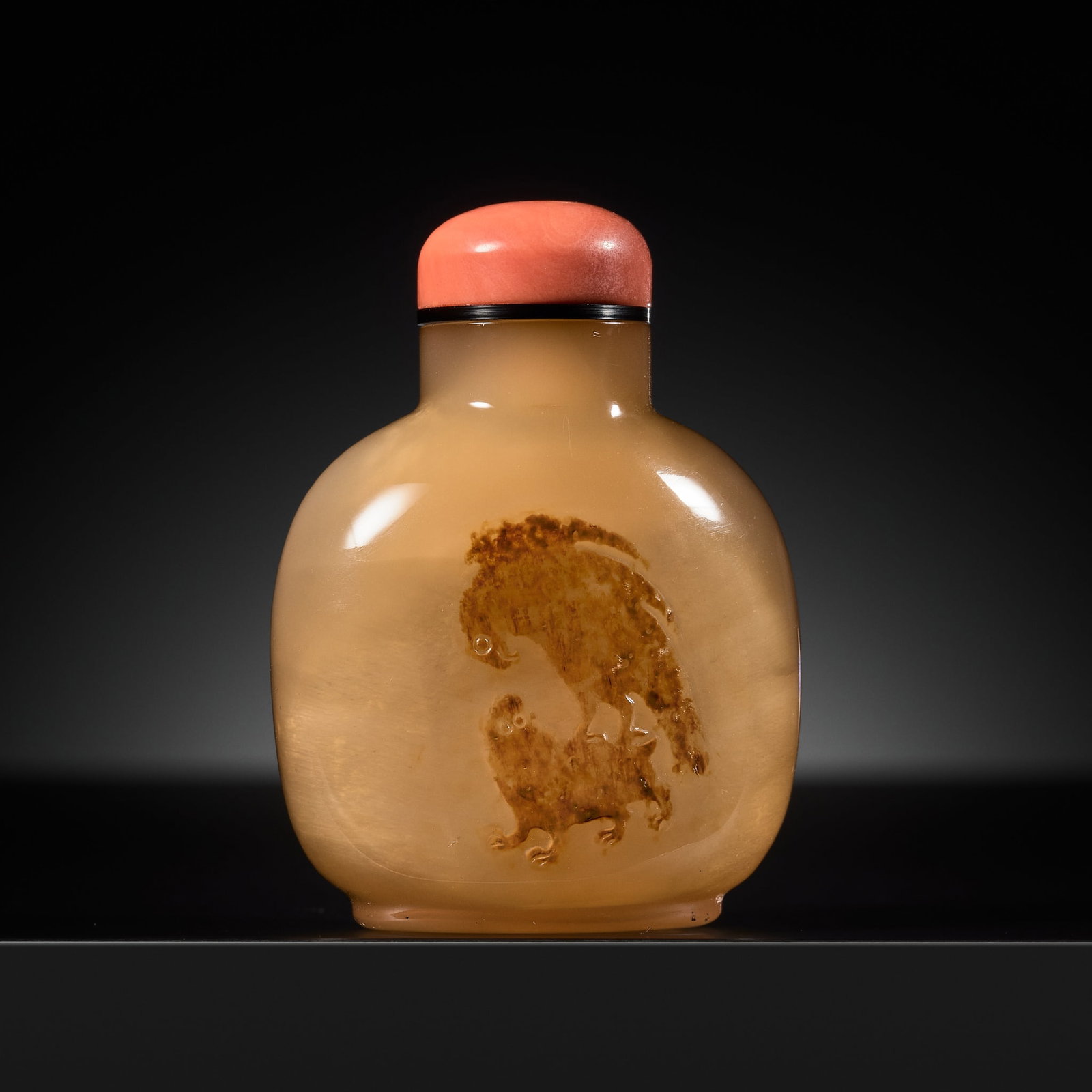 A SHADOW AGATE 'EAGLE AND BEAR' SNUFF BOTTLE, OFFICIAL SCHOOL, 1760-1850: A SHADOW AGATE 'EAGLE AND BEAR' SNUFF BOTTLE, OFFICIAL SCHOOL, 1760-1850 Well hollowed, the bottle of rounded-square form, supported on a short oval foot ring and rising to a cylindrical neck with a f